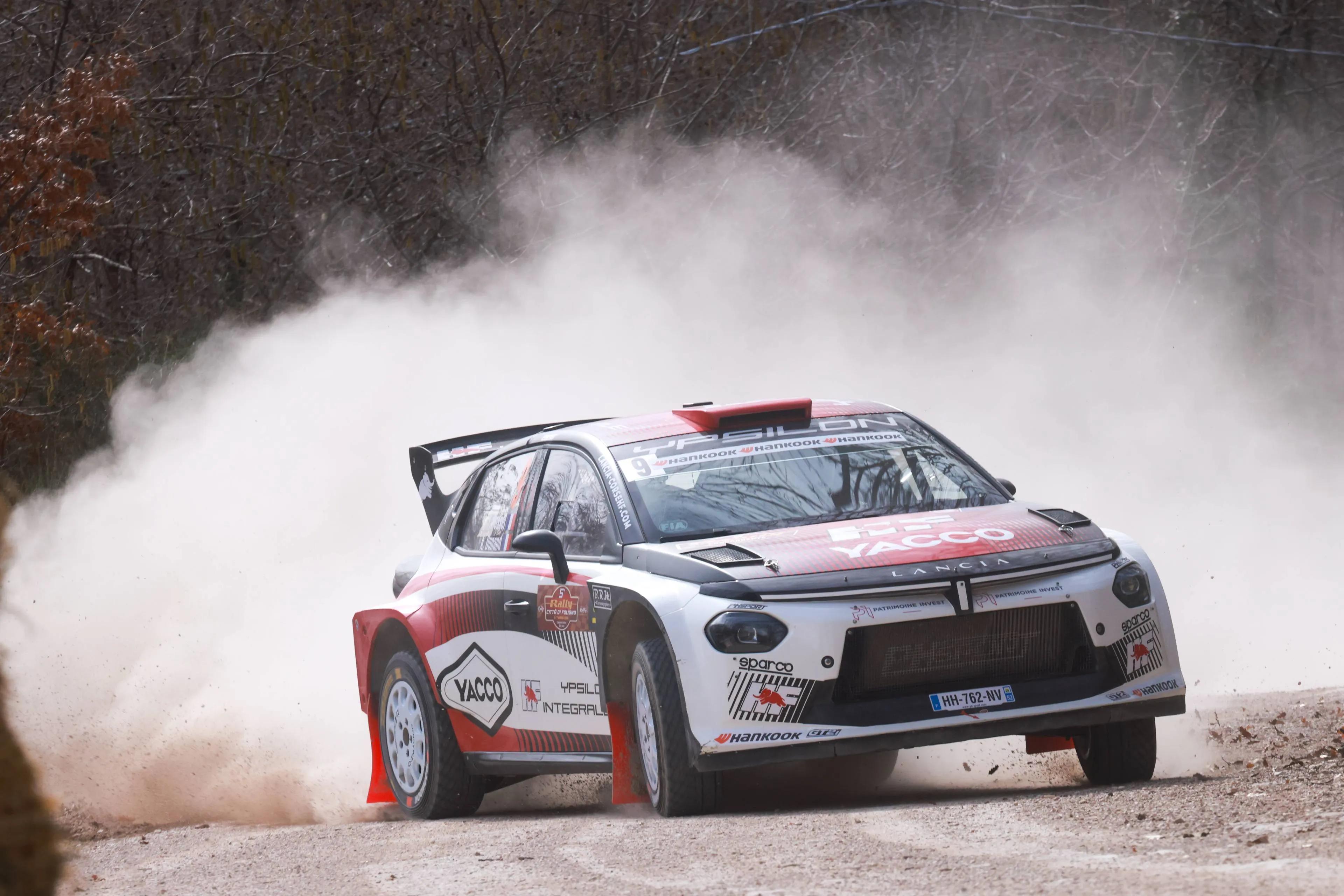 Nell'immagine si vede la Lancia Ypsilon Rally2 HF Integrale che esegue una derapata su una strada sterrata