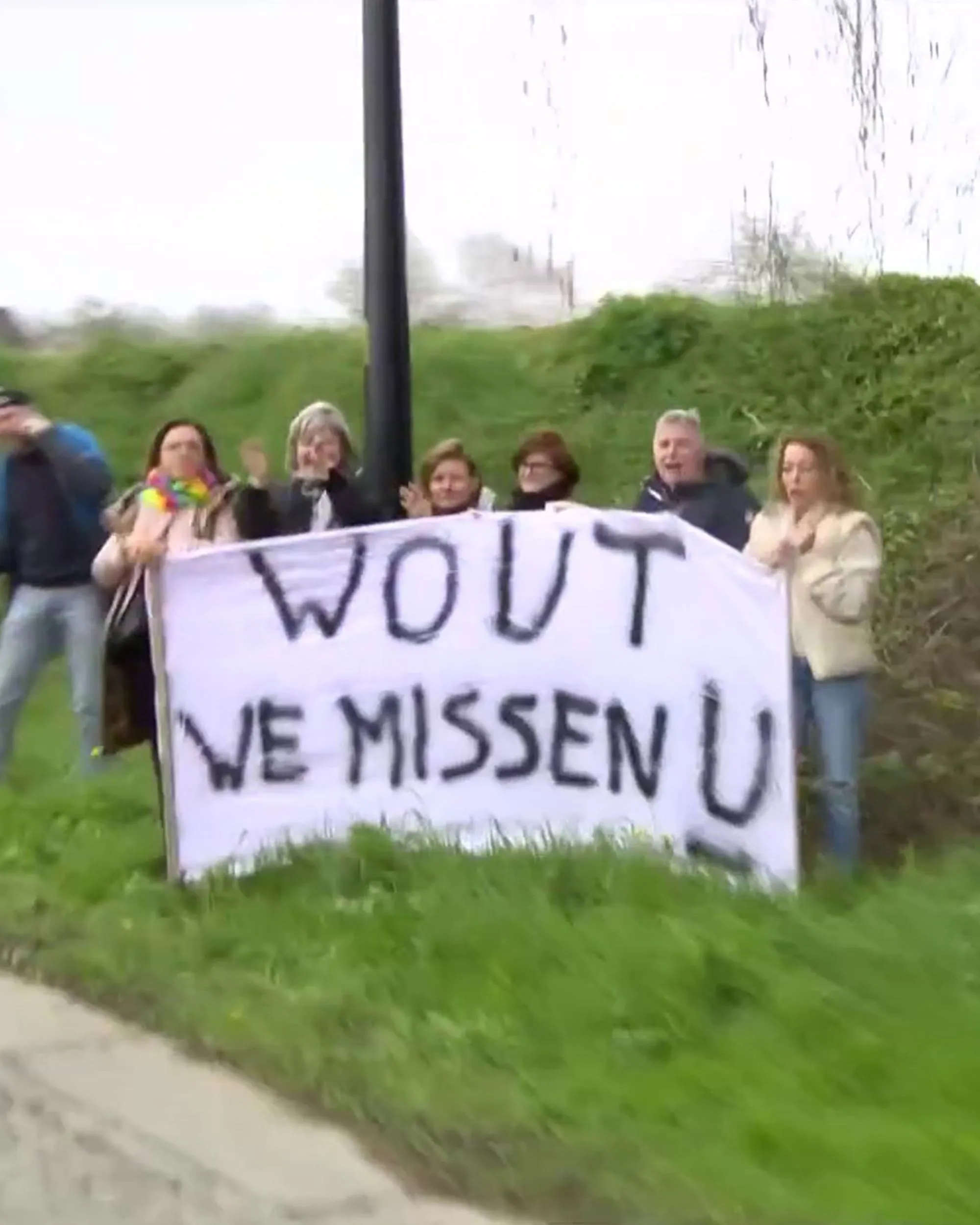 Fans on the roadside show support for absent Wout van Aert at the Tour of Flanders