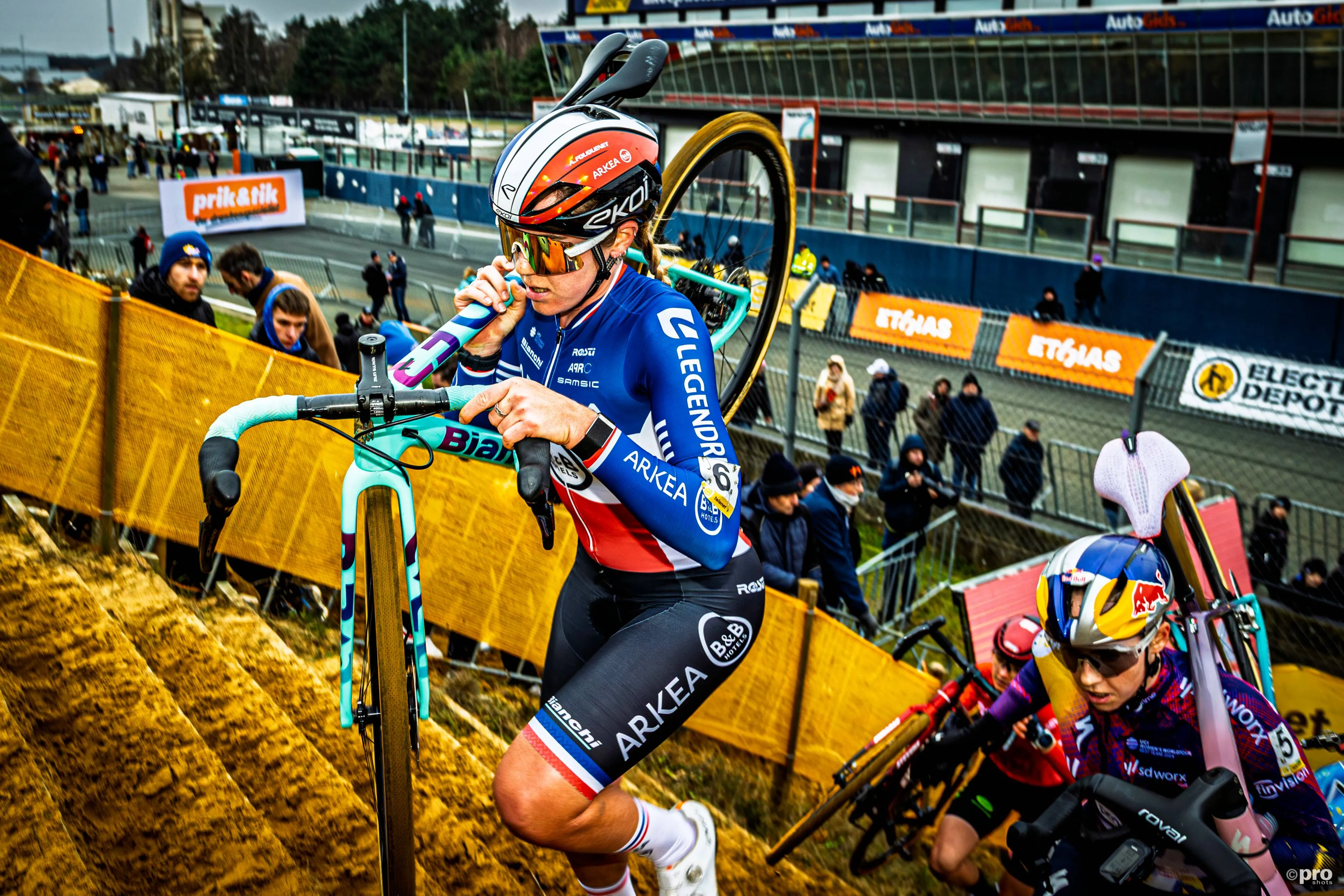 Amandine Fouquenet running up stairs during a cyclocross race