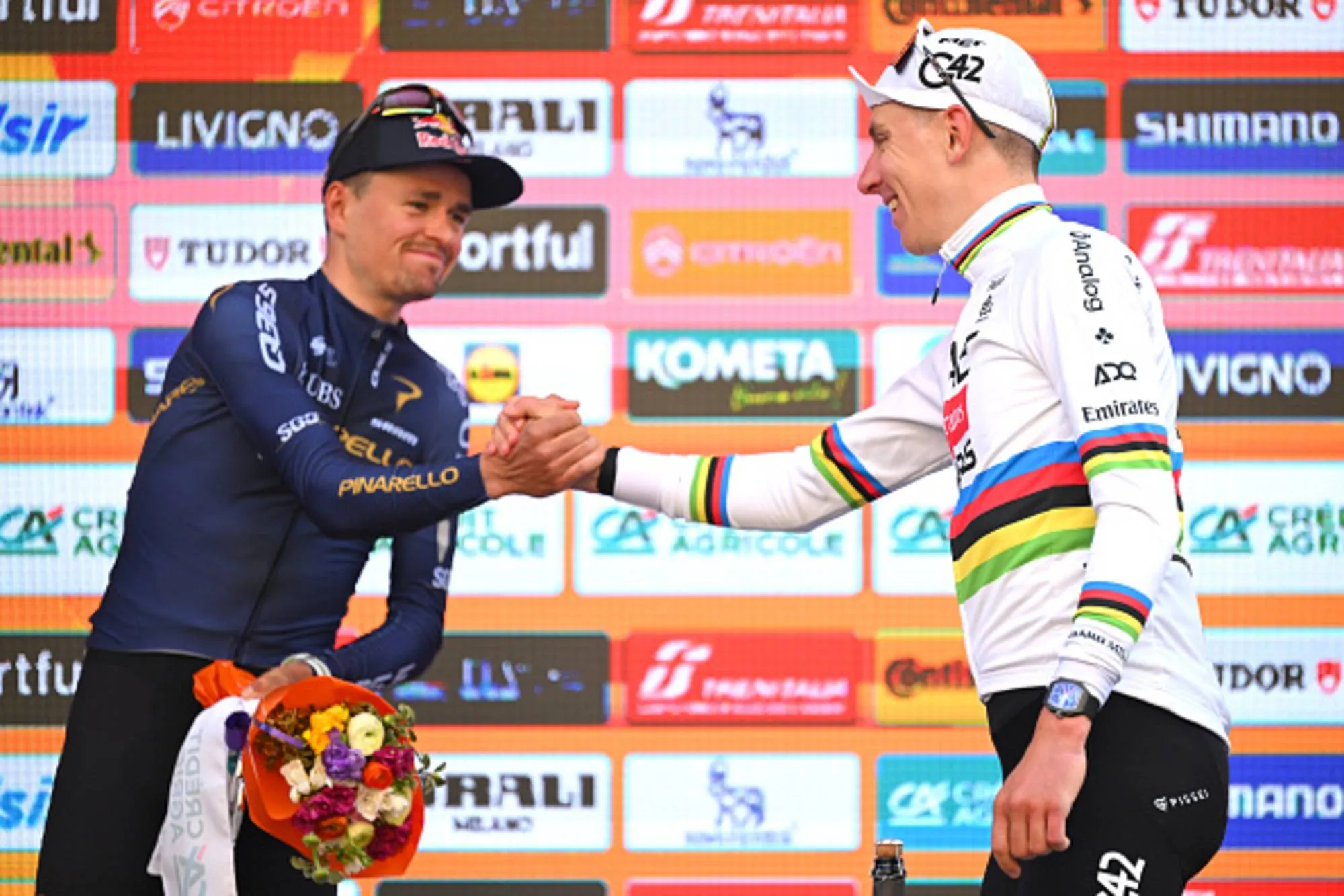 Tadej Pogacar and Tom Pidcock shake hands on the final podium of Milano-Sanremo 2026
