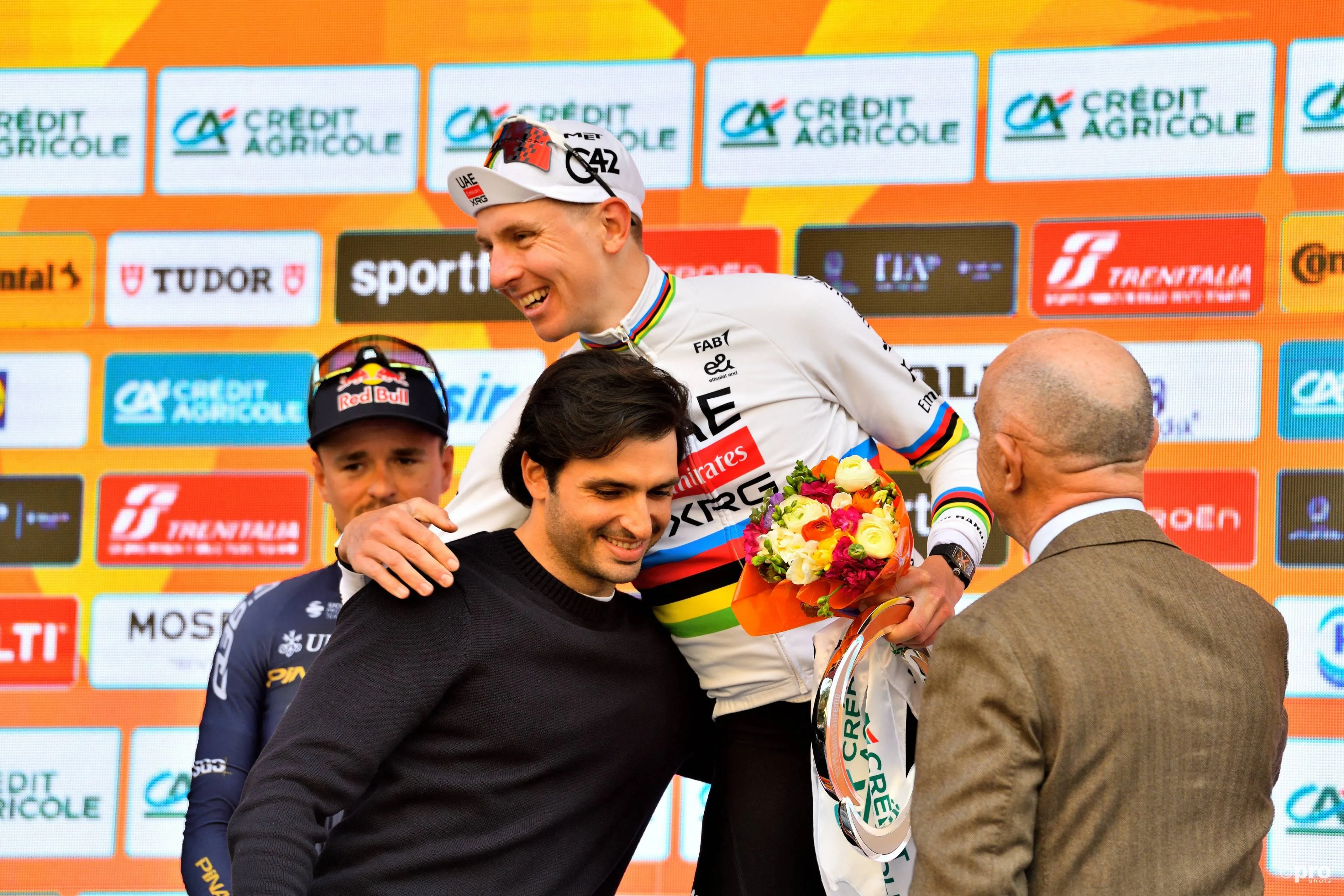 Tadej Pogacar and Carlos Sainz Jr. at the podium of the 2026 Milano-Sanremo
