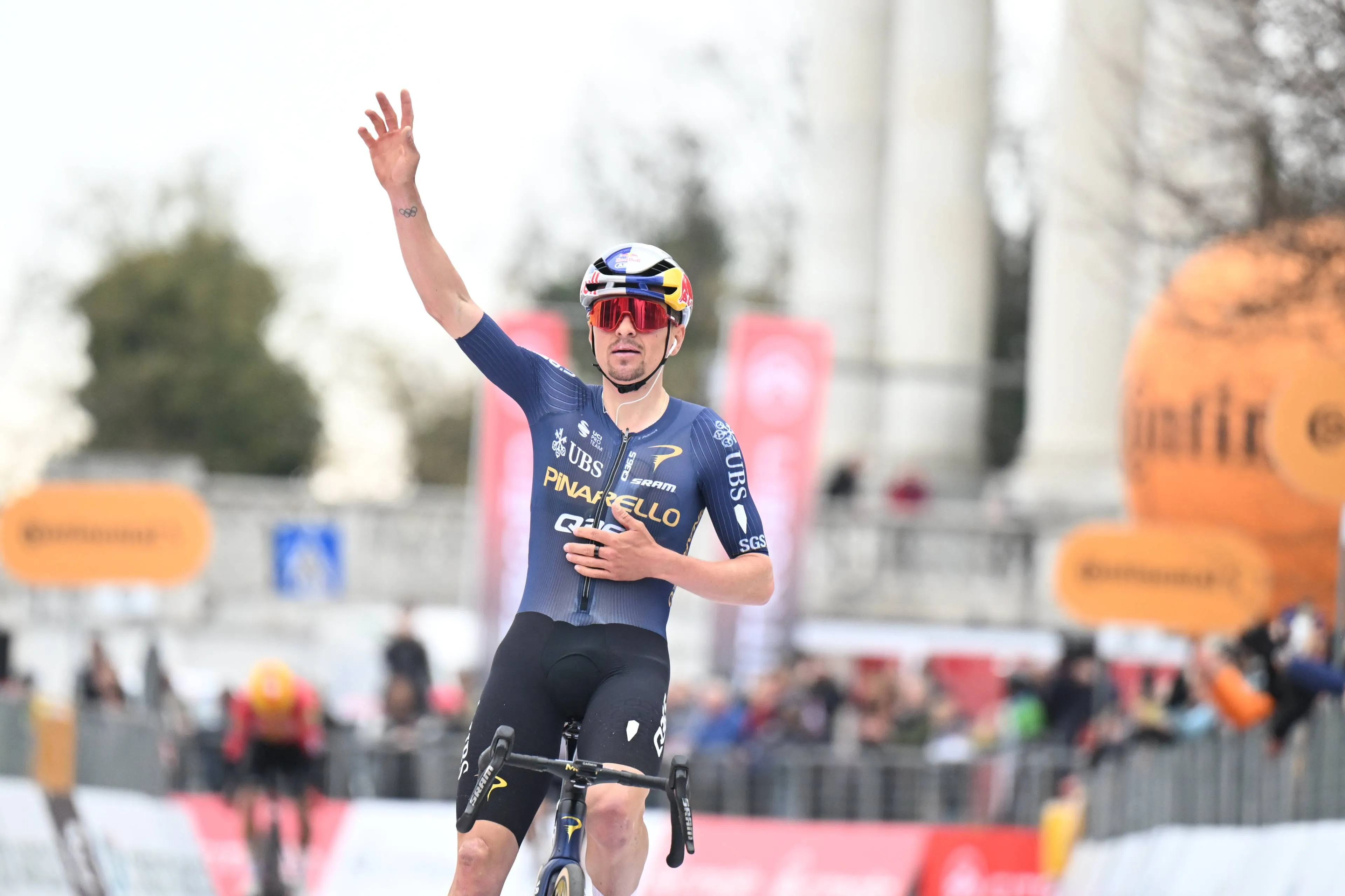 Tom Pidcock raises one arm to the sky as he wins Milano-Torino 2026