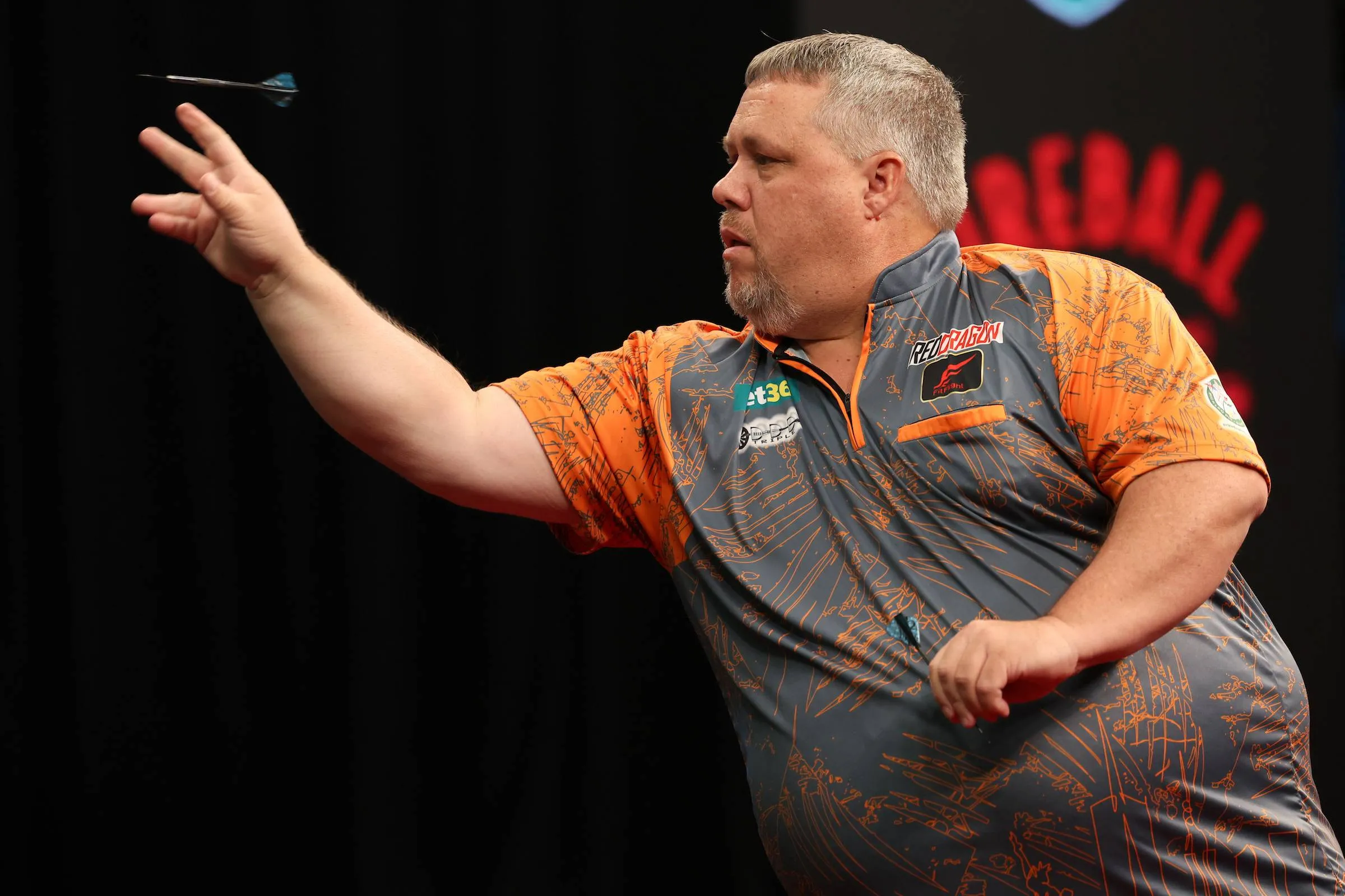 jason brandon throwing a dart on stage