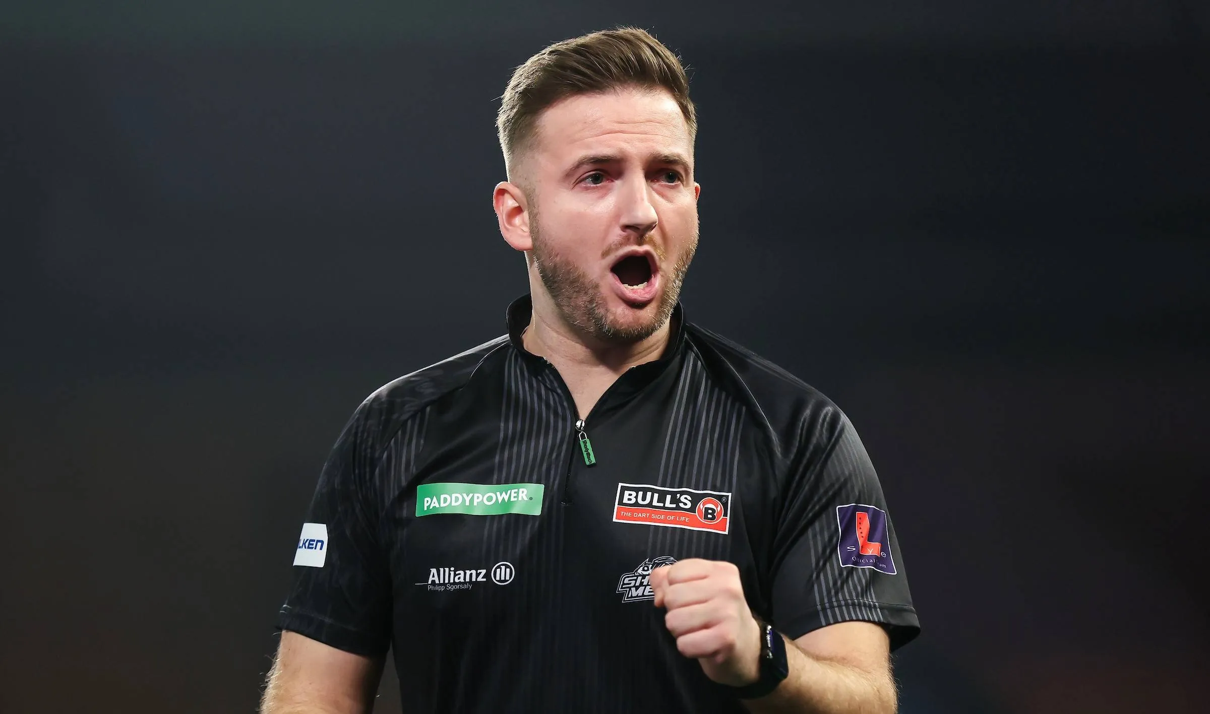 Arno Merk with mouth open celebrates winning leg.