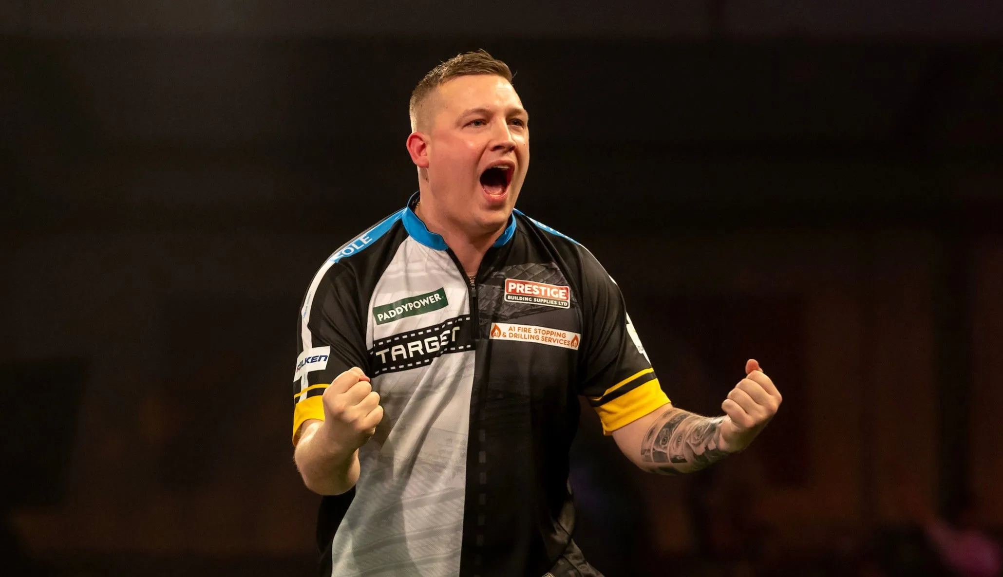 Chris Dobey pumps his fists after hitting a double