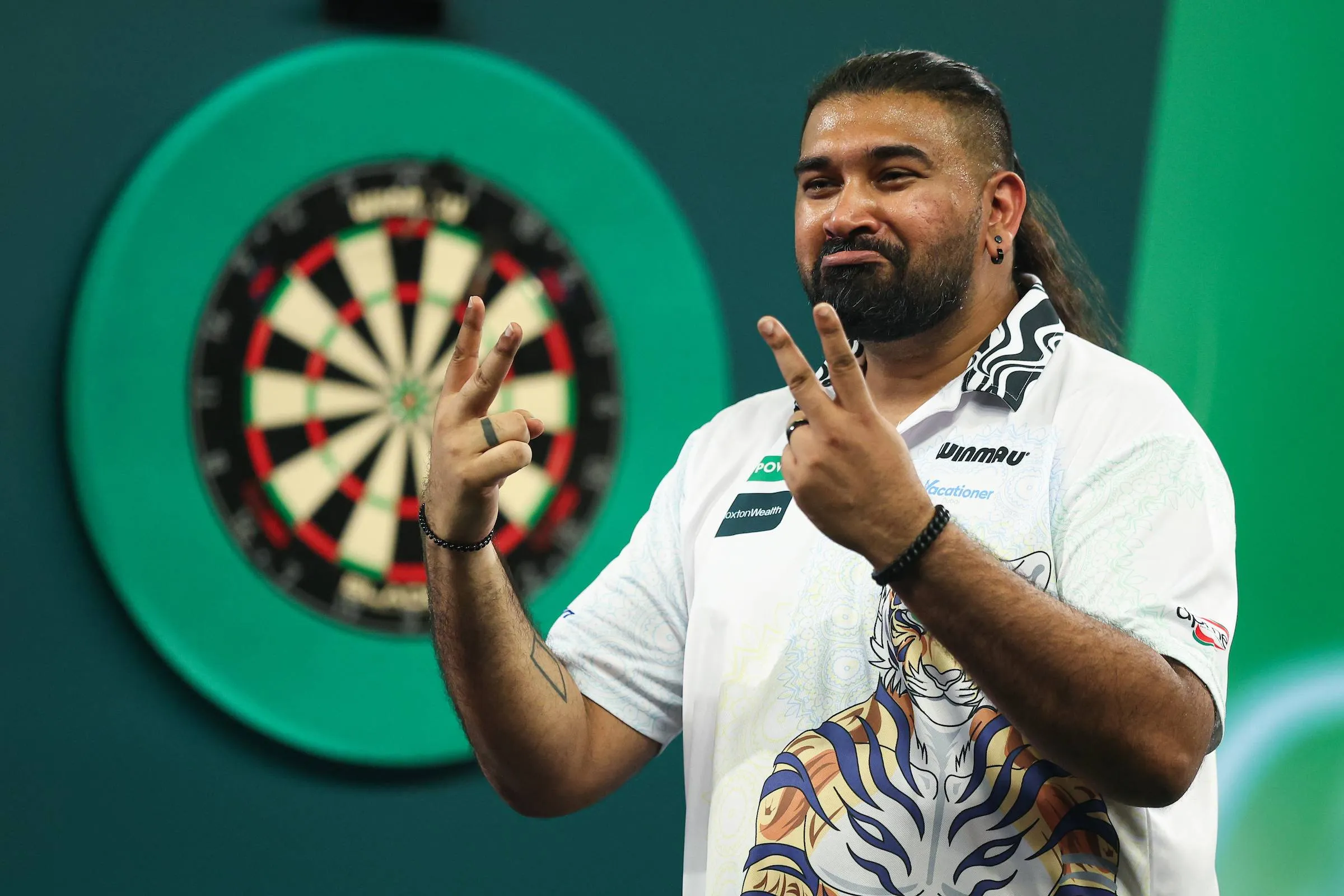 Nitin Kumar does gesture in PDC World Darts Championship win.