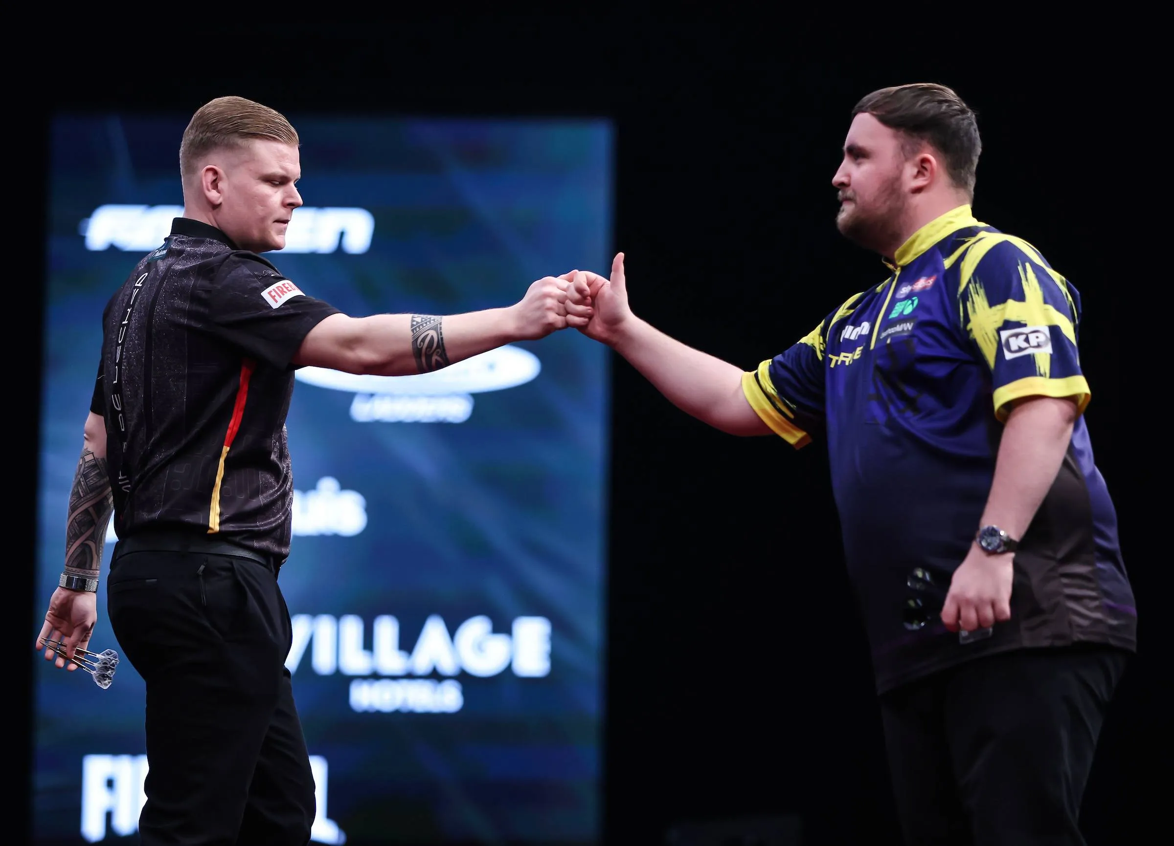 Mike de Decker and Luke Littler fistbump before their Winmau World Masters contest