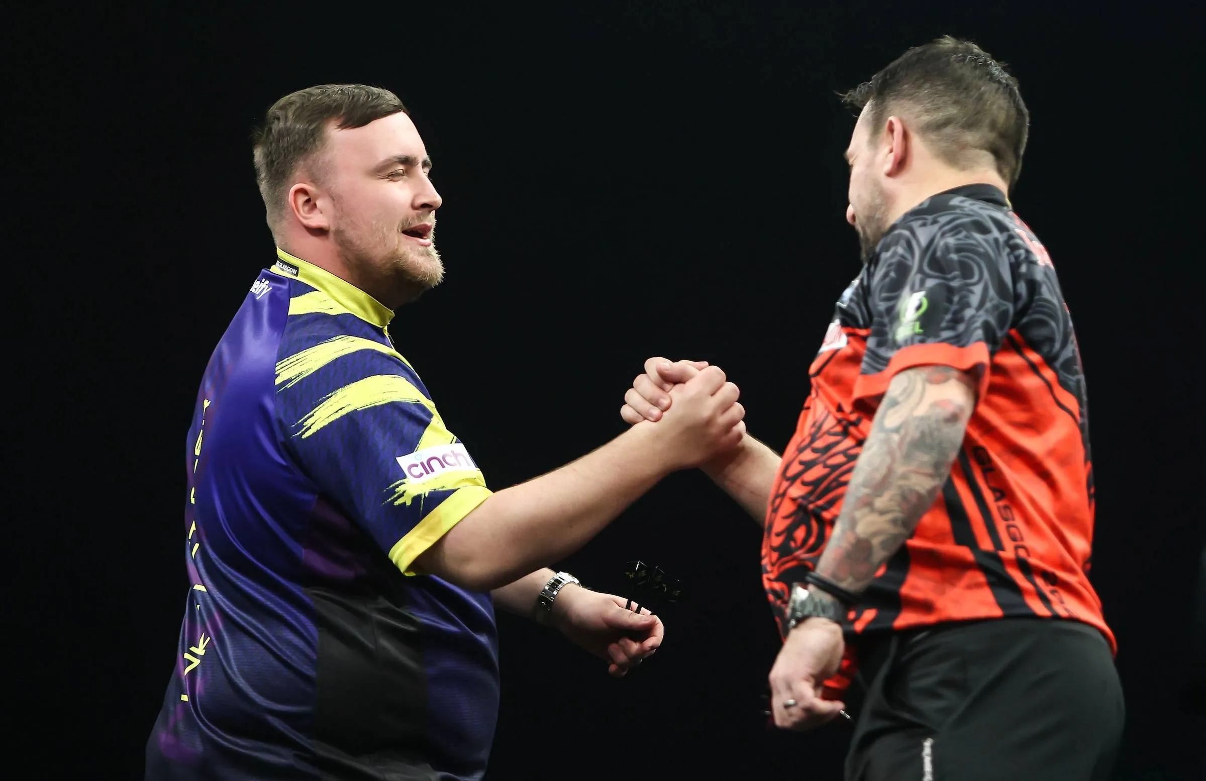 Luke Littler and Jonny Clayton shake hands ahead of their match on night 3 of the 2026 Premier League Darts in Glasgow