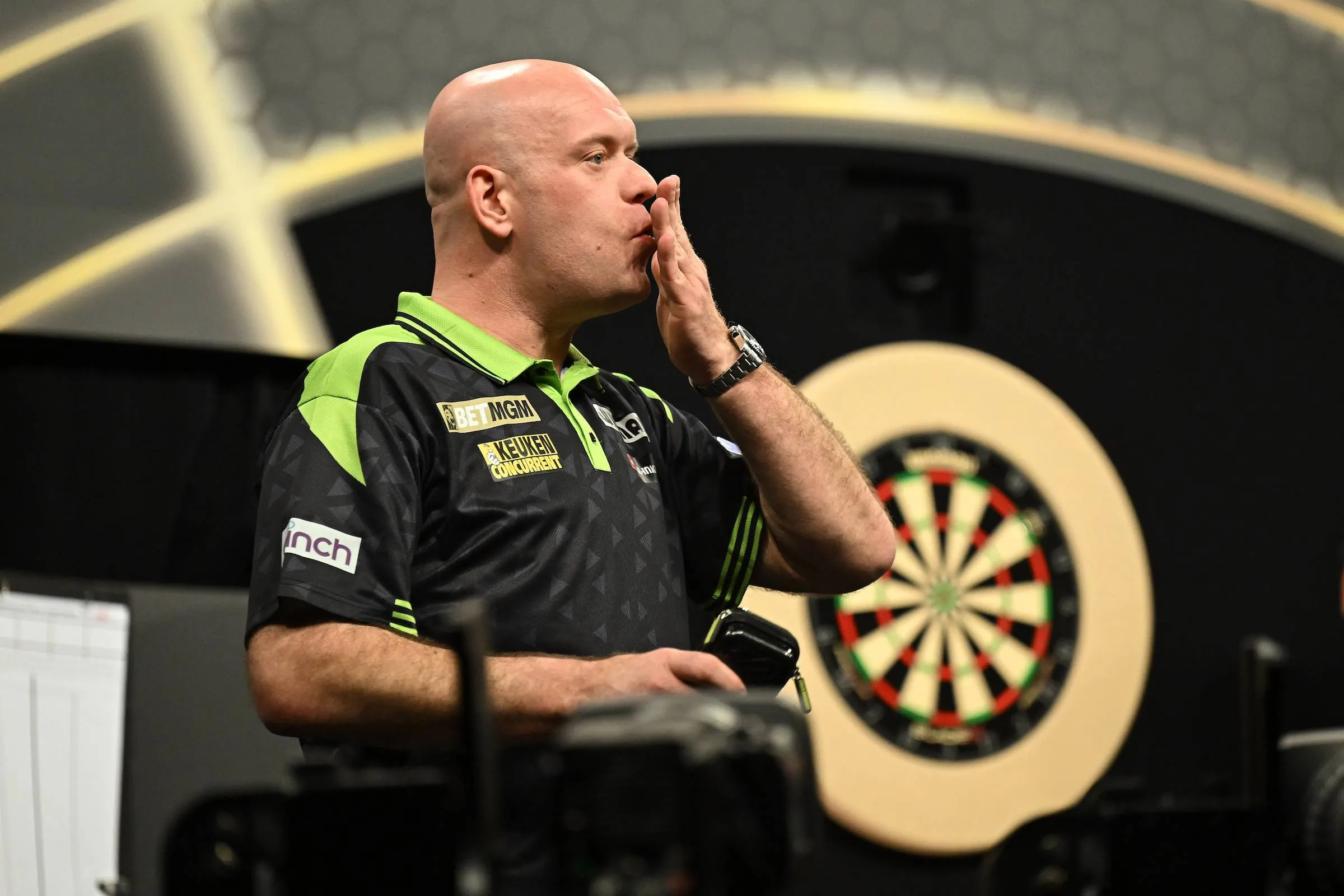 Michael van Gerwen blows a kiss with his hand.