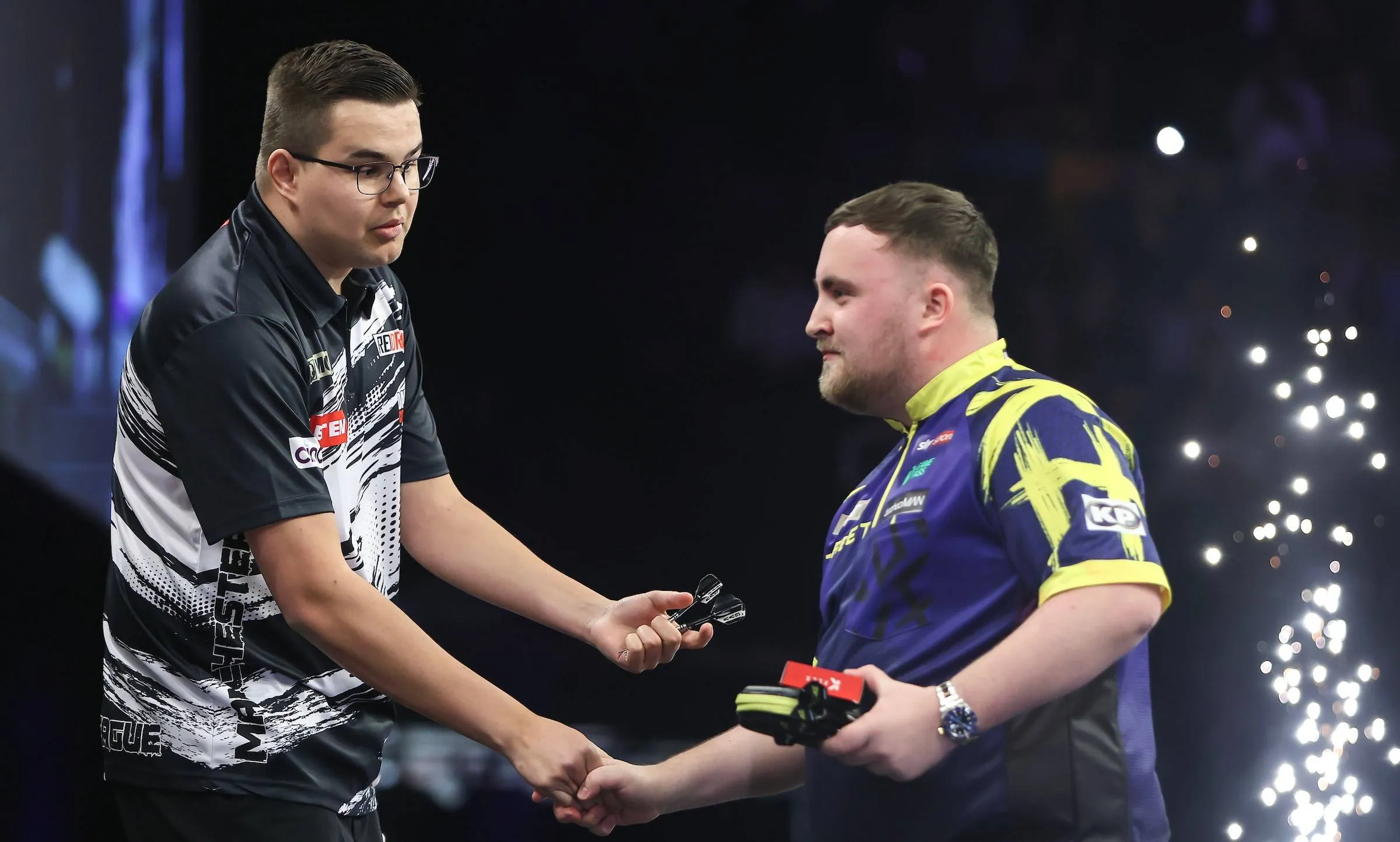 Gian van Veen and Luke Littler with an awkward handshake