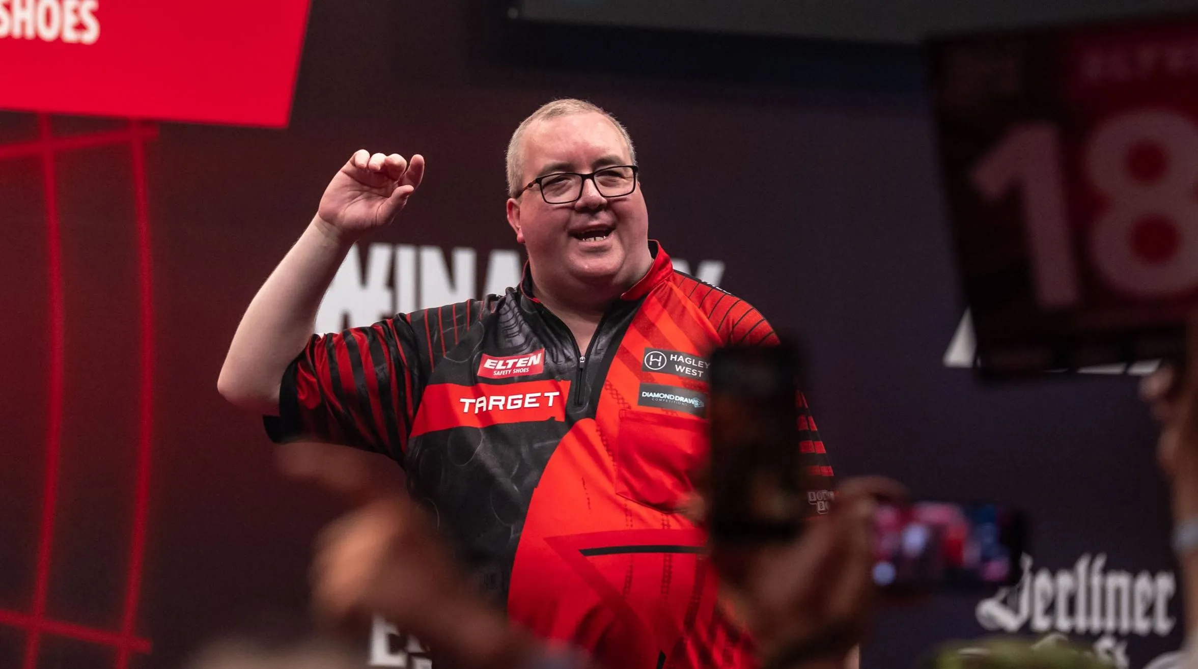 Stephen Bunting raising his arm on stage