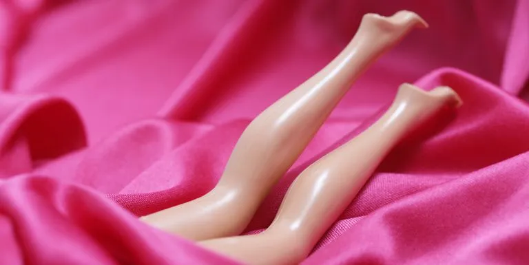 doll legs appearing in middle of pink silk royalty free image 139739651 1546857573