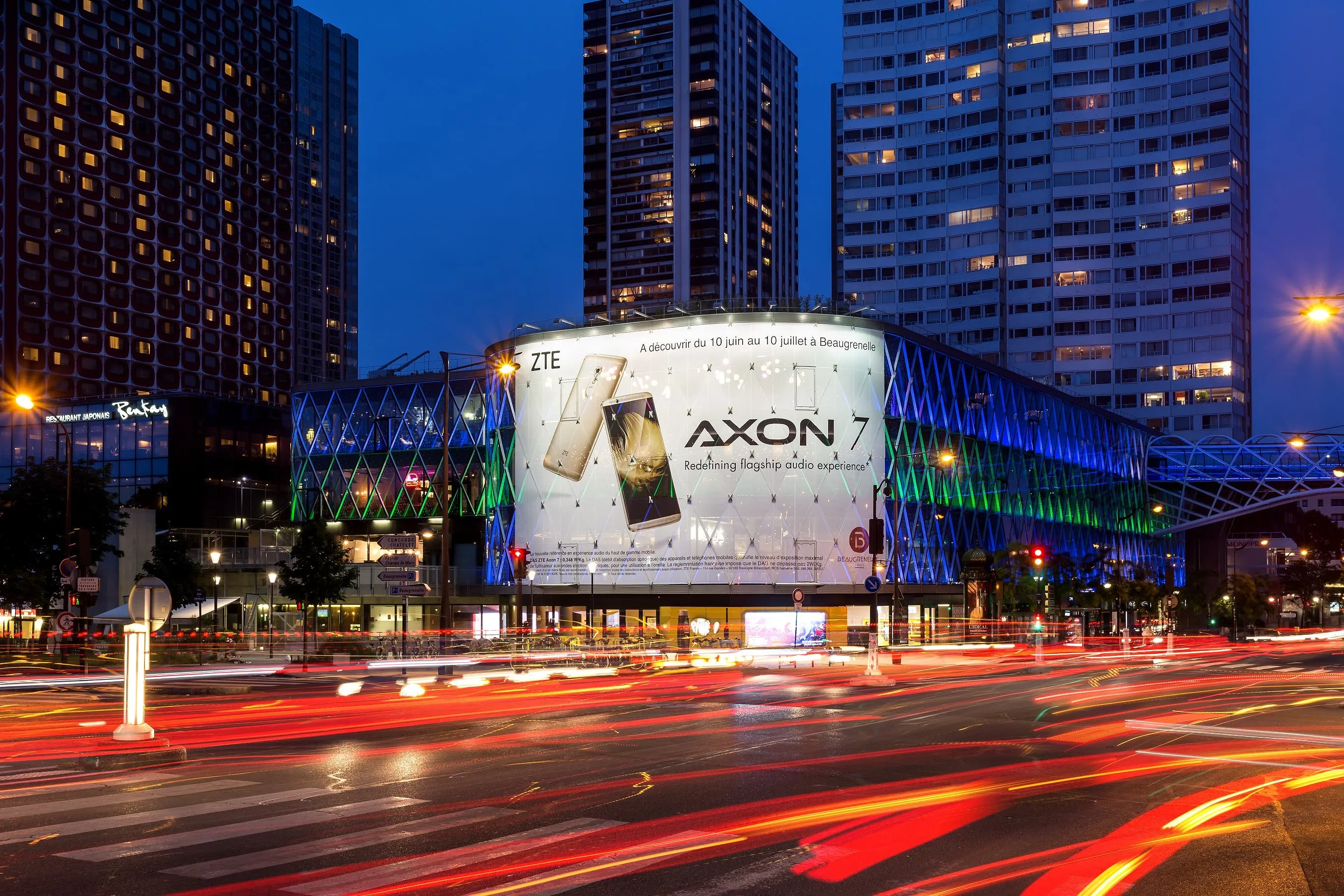 a zte axon 7 advertisement adorns an ultra modern building in paris
