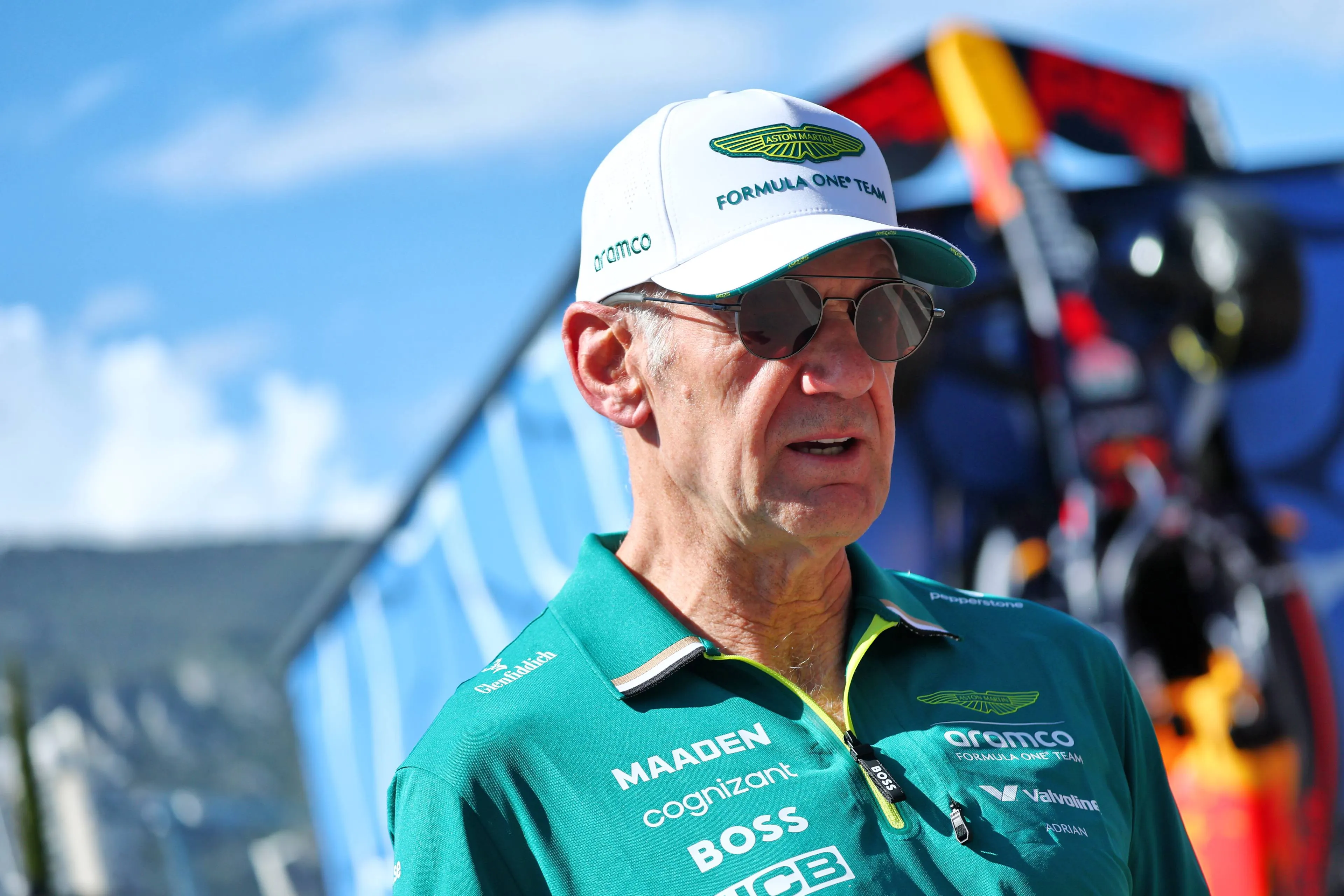 adrian newey with a red bull demo car in the background