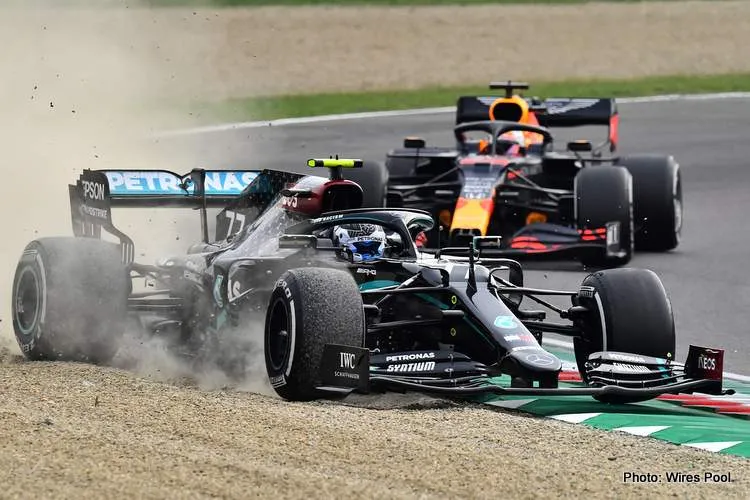 mercedes of valtteri bottas runs wide at imola as hes pursued by max verstappens red bull during the 2020 f1 emilia romagna grand prix
