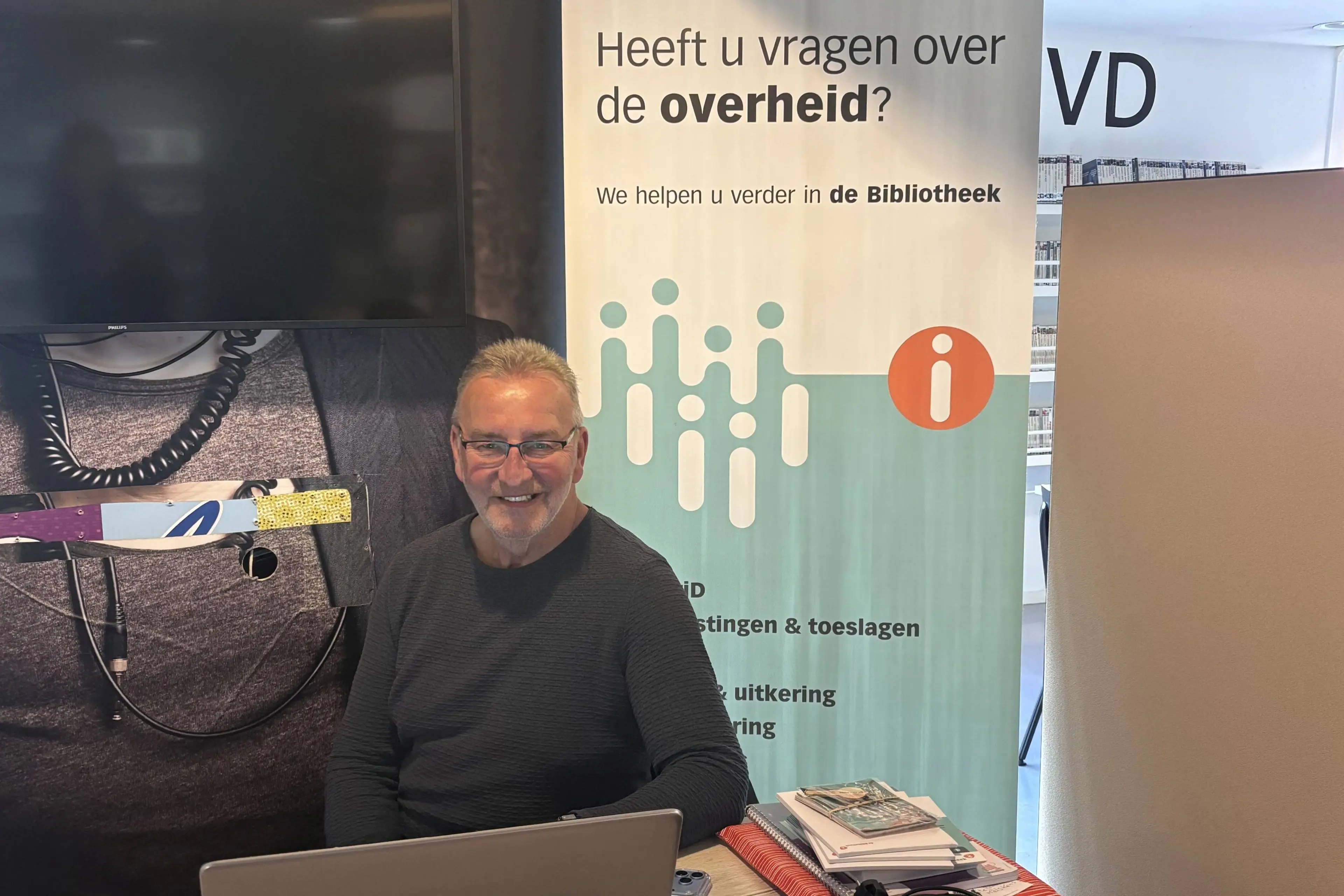 Vrijwilliger Knud zit elke donderdagochtend klaar bij het IDO in Bibliotheek Marienburg. Foto OBGZ