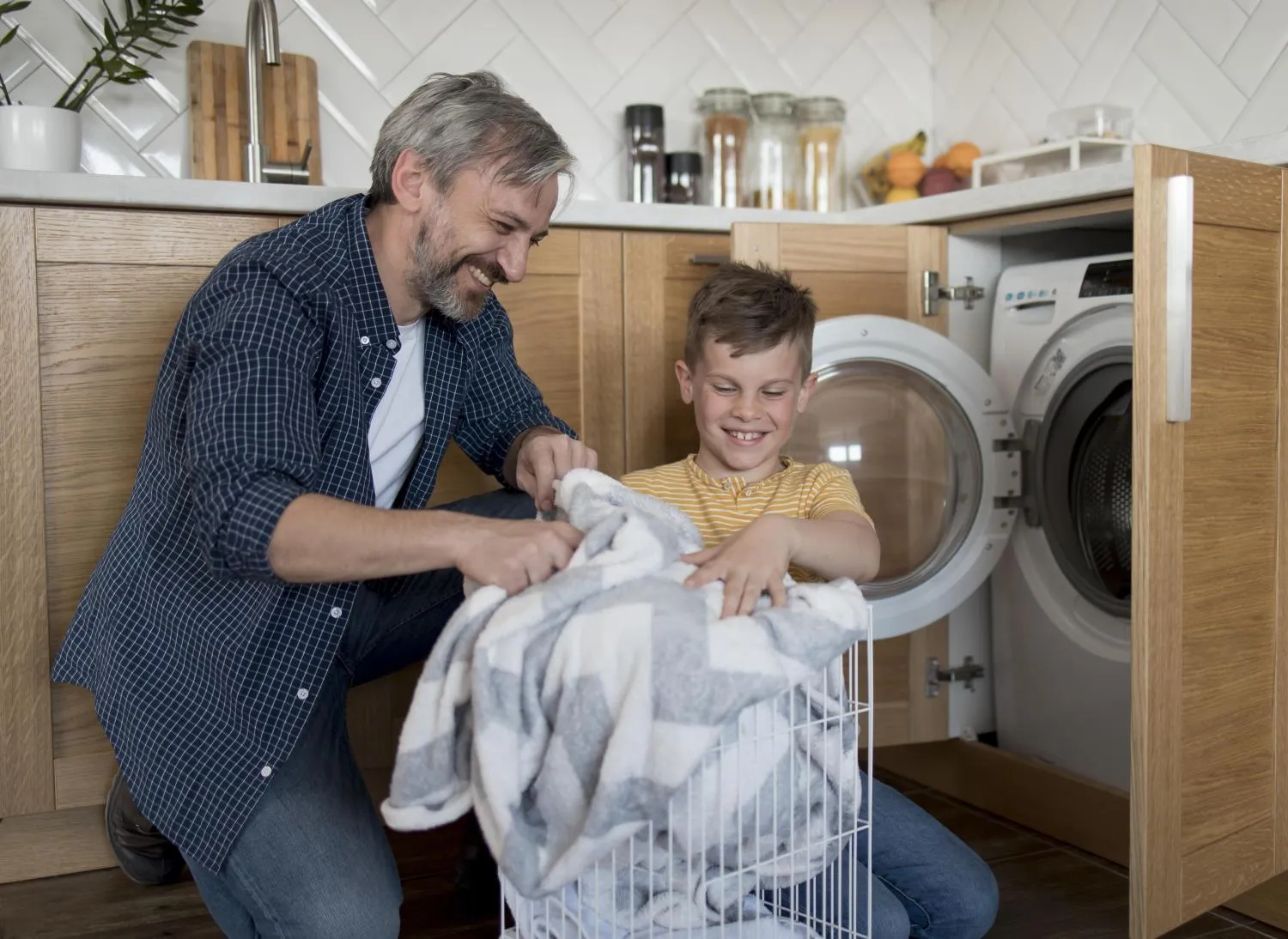 medium shot father kid doing laundry