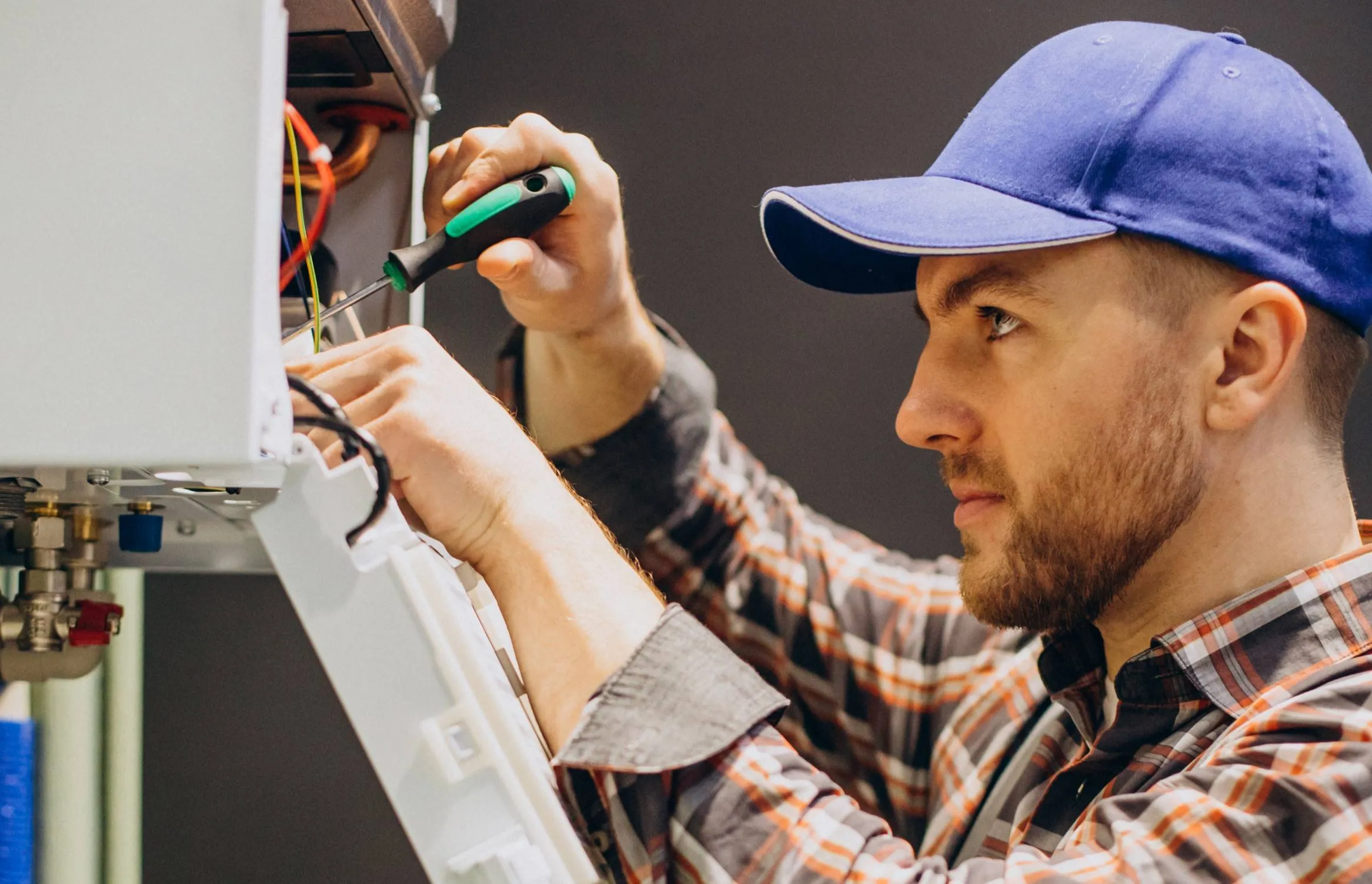 service-man-adjusting-house-heating-system