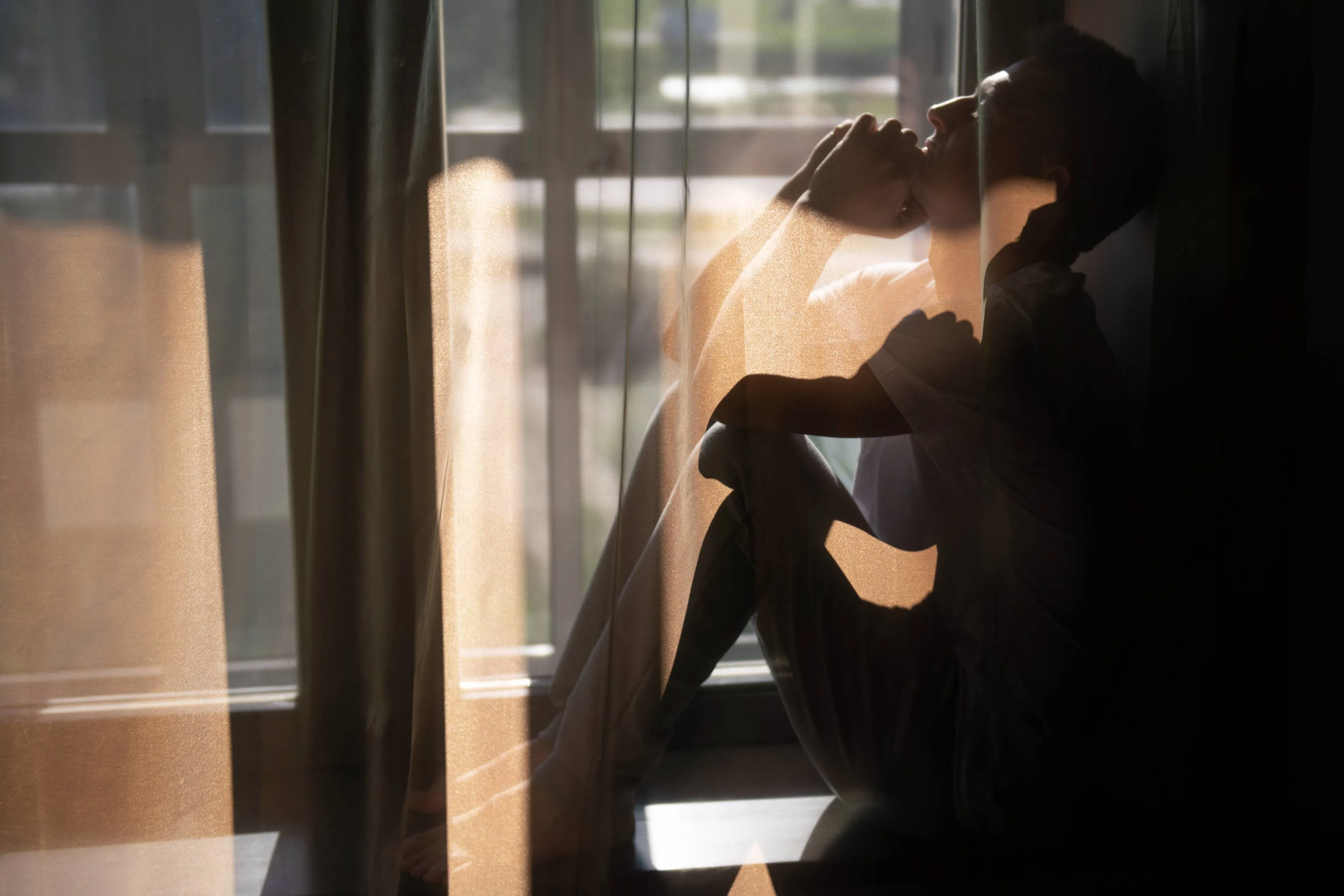 creative-portrait-man-with-curtains-shadows-from-window