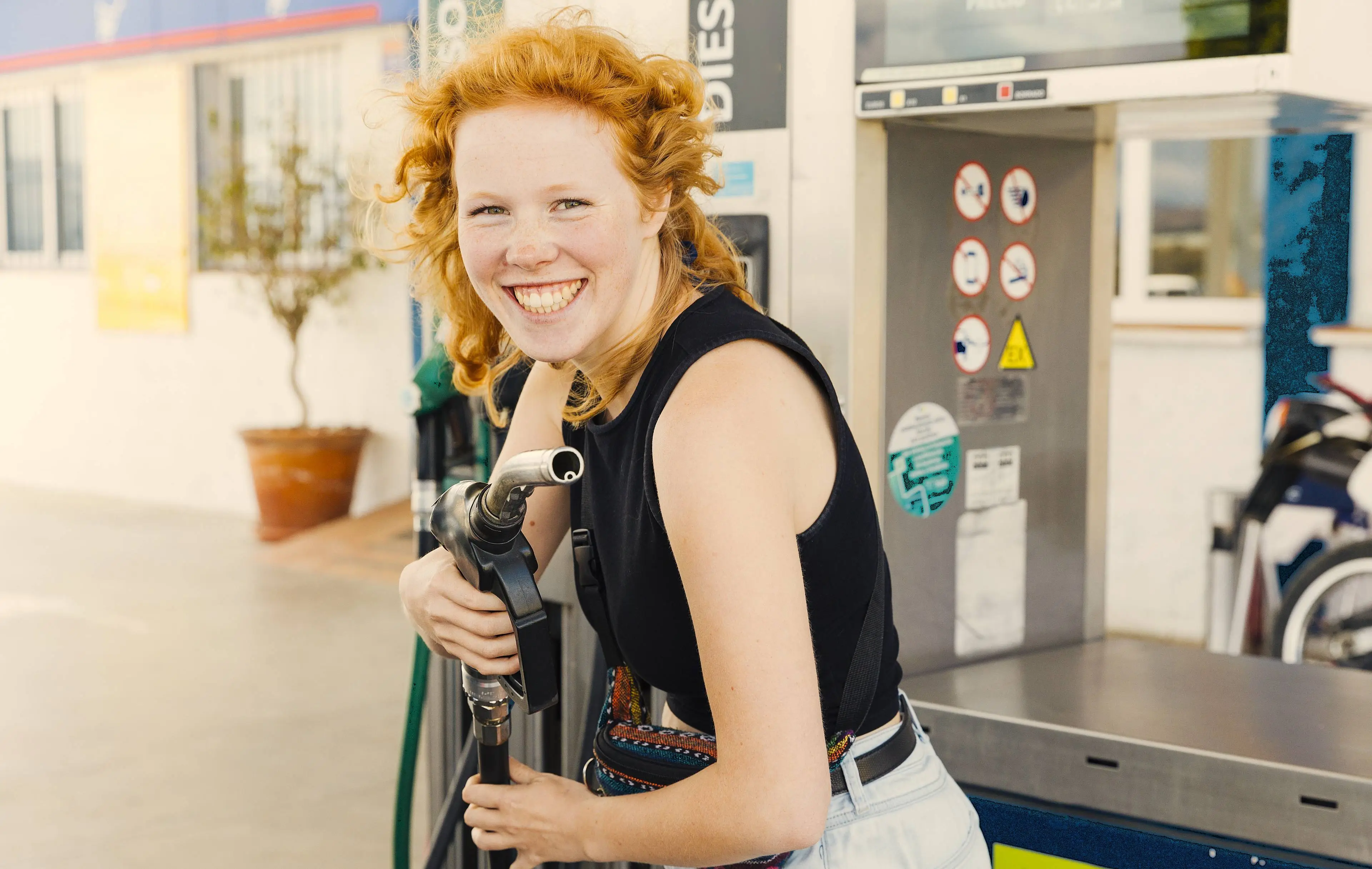 woman-having-fun-with-filling-gun-smiling-looking-camera