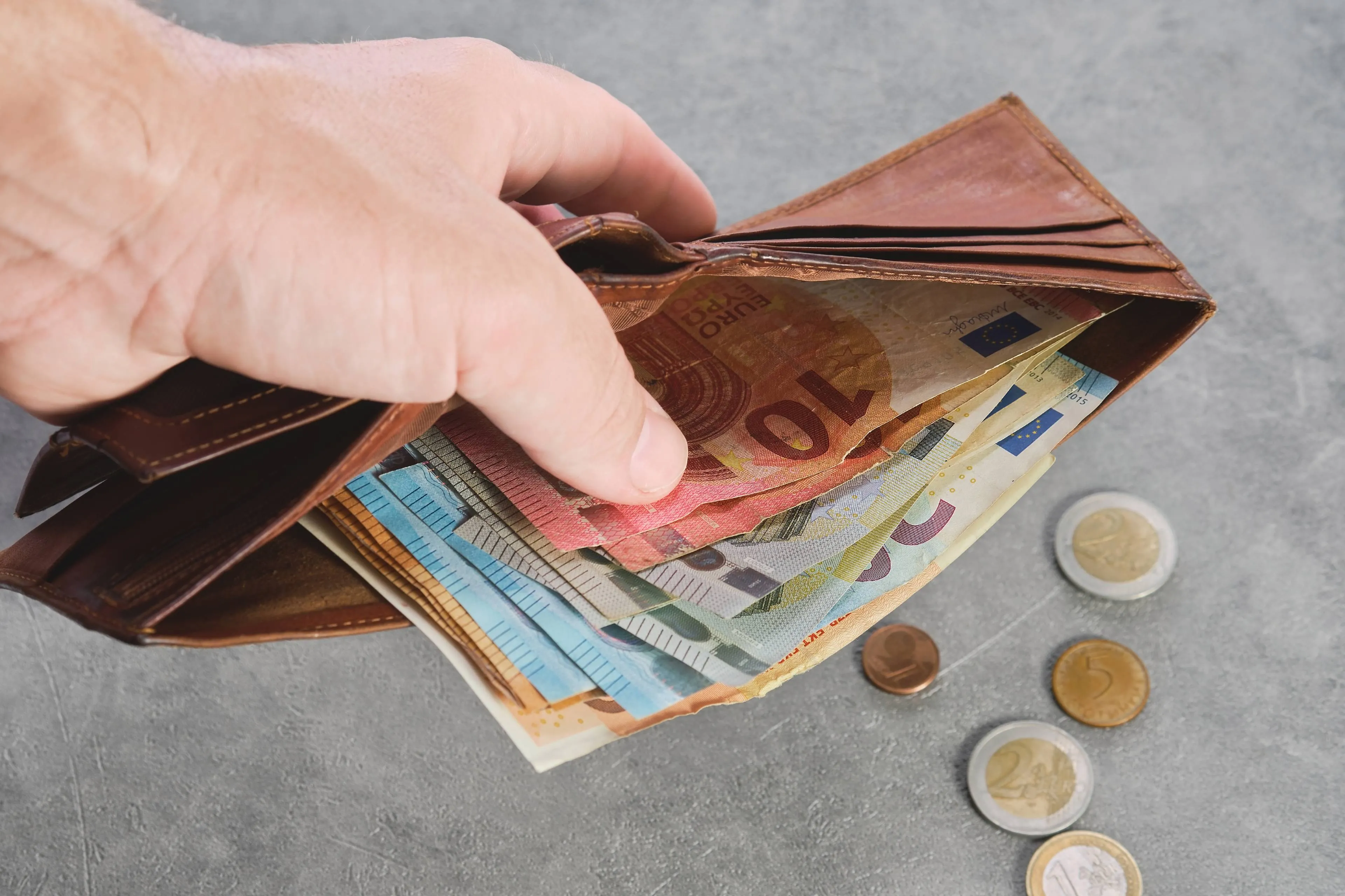 senior man holds wallet with euro banknotes his hand euro banknotes wallet wallet with money man s hand background idea paying taxes buying paying services