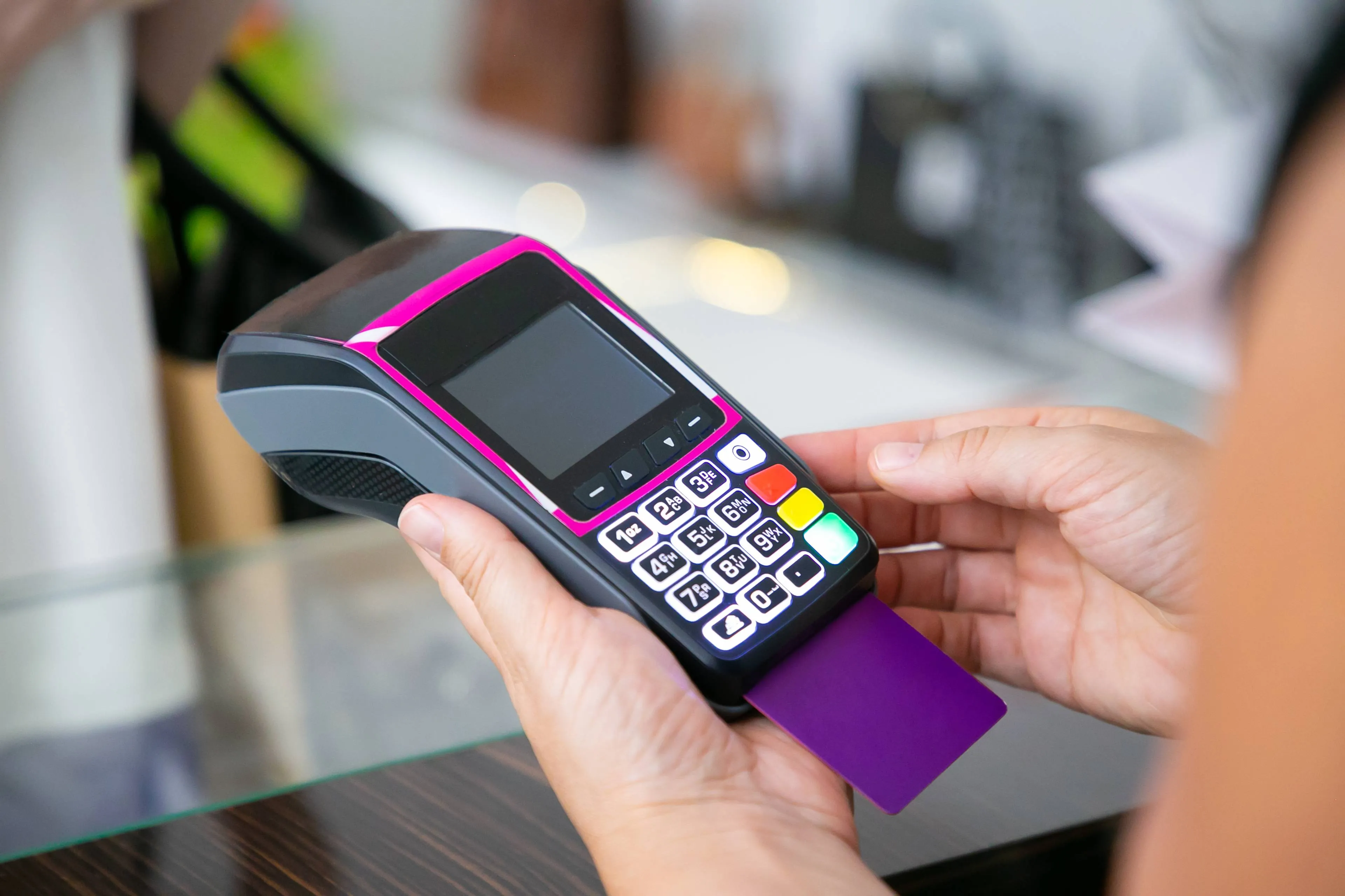 clothes store cashier operating payment process with pos terminal credit card cropped shot closeup hands shopping purchase concept