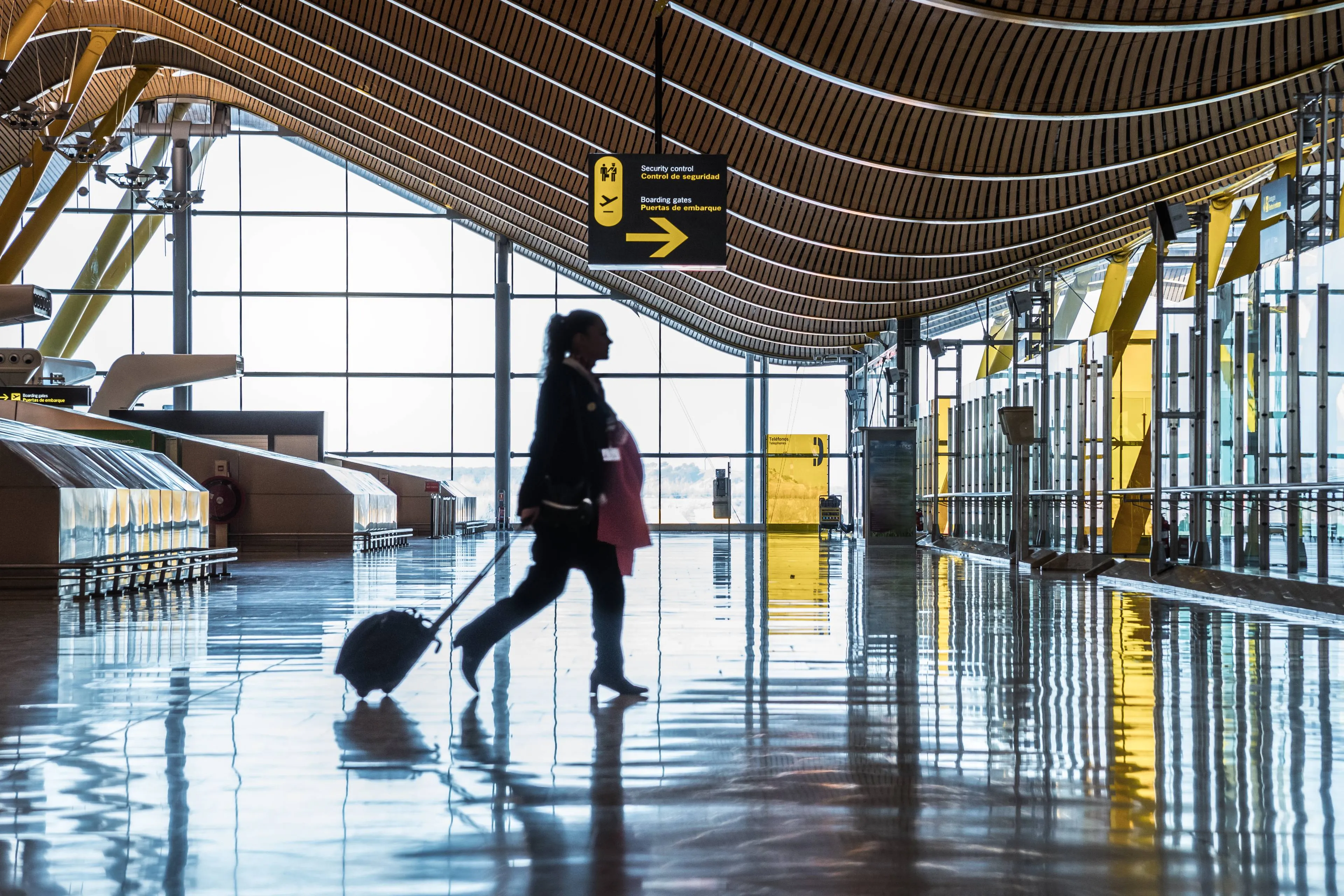 airport-terminal-with-people-moving-silhouettes-sunray