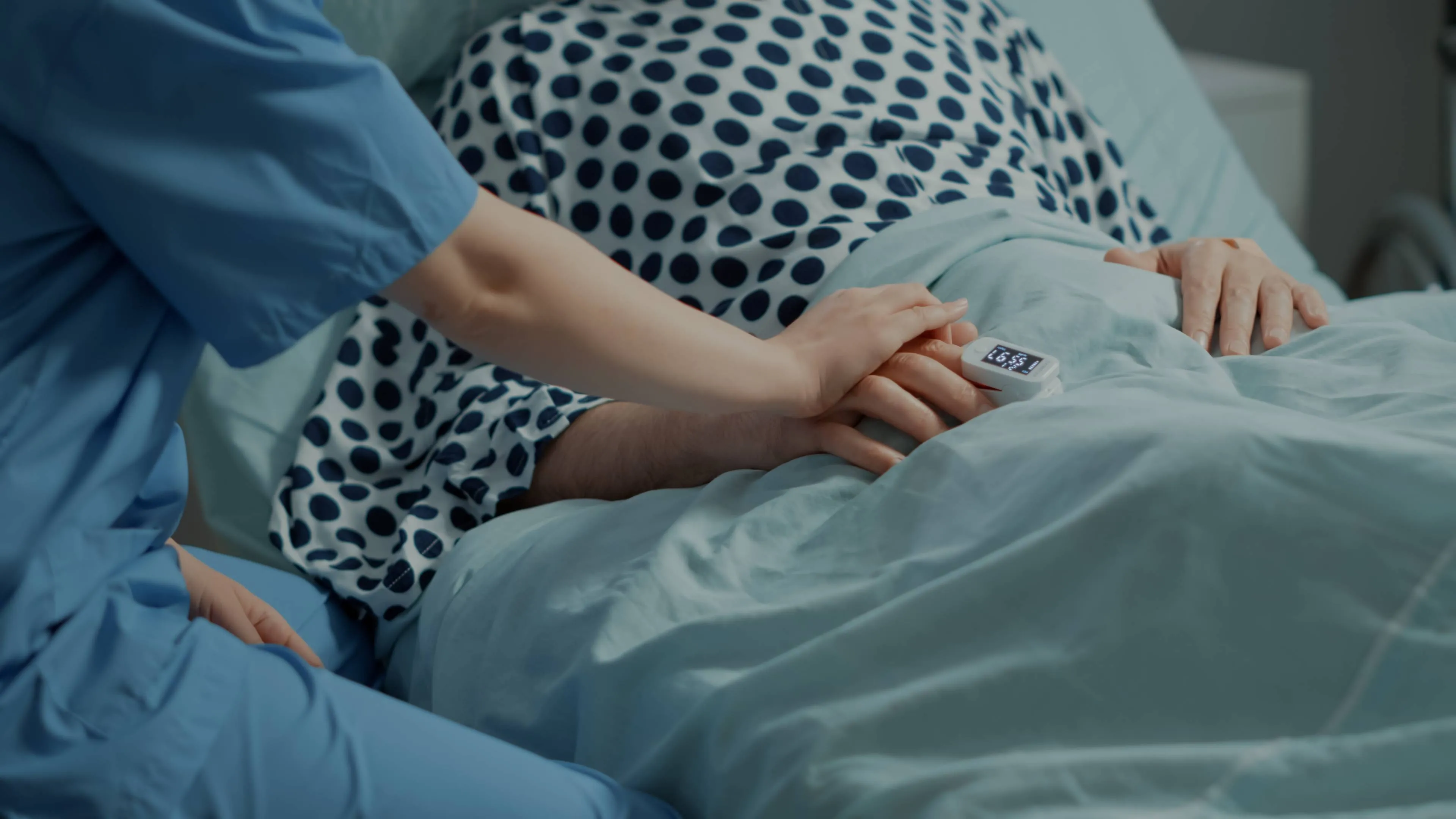 close-up-nurse-comforting-ill-patient-hospital-ward