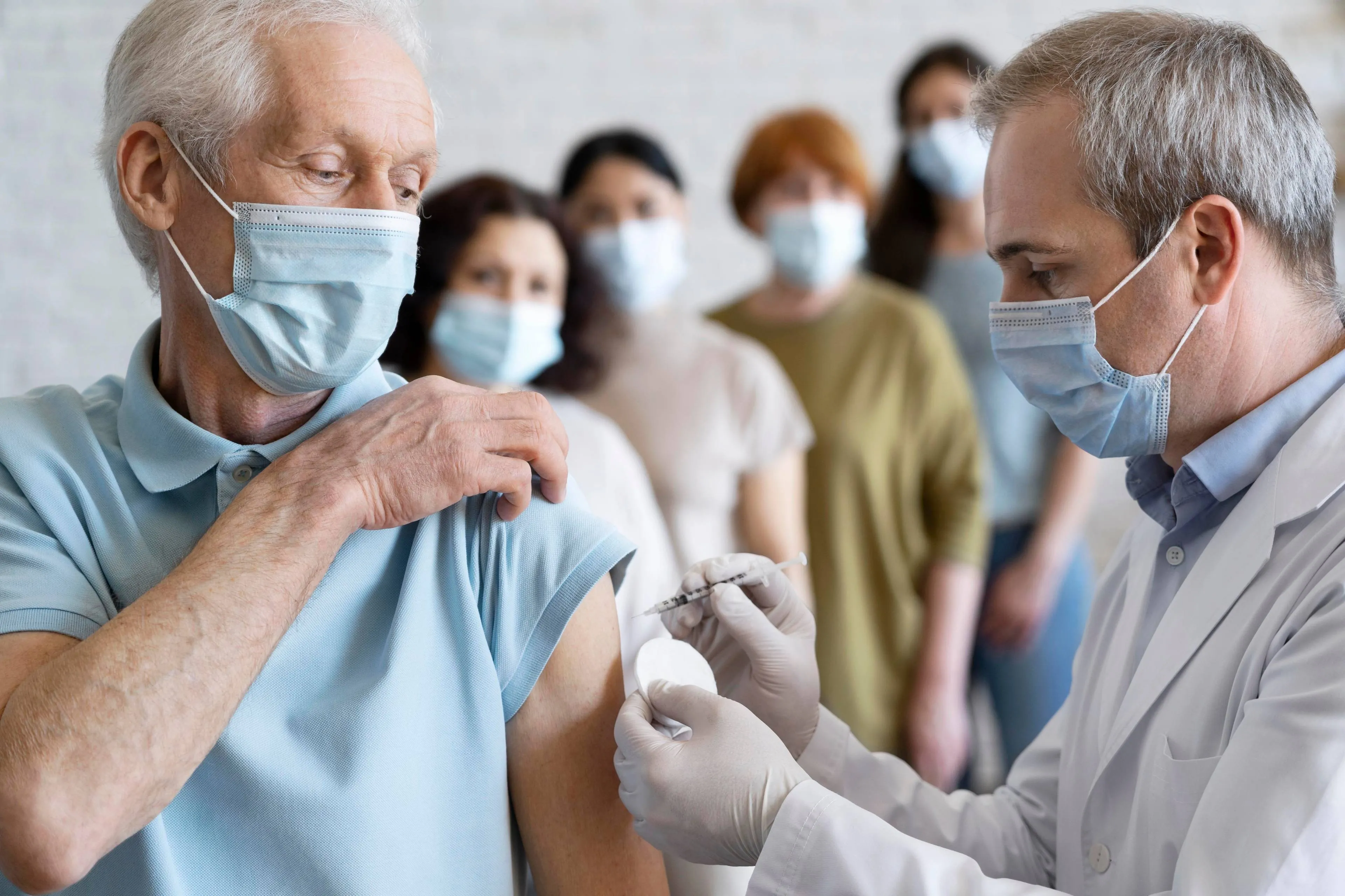 man-getting-vaccine-shot-by-doctor-with-medical-mask (3)