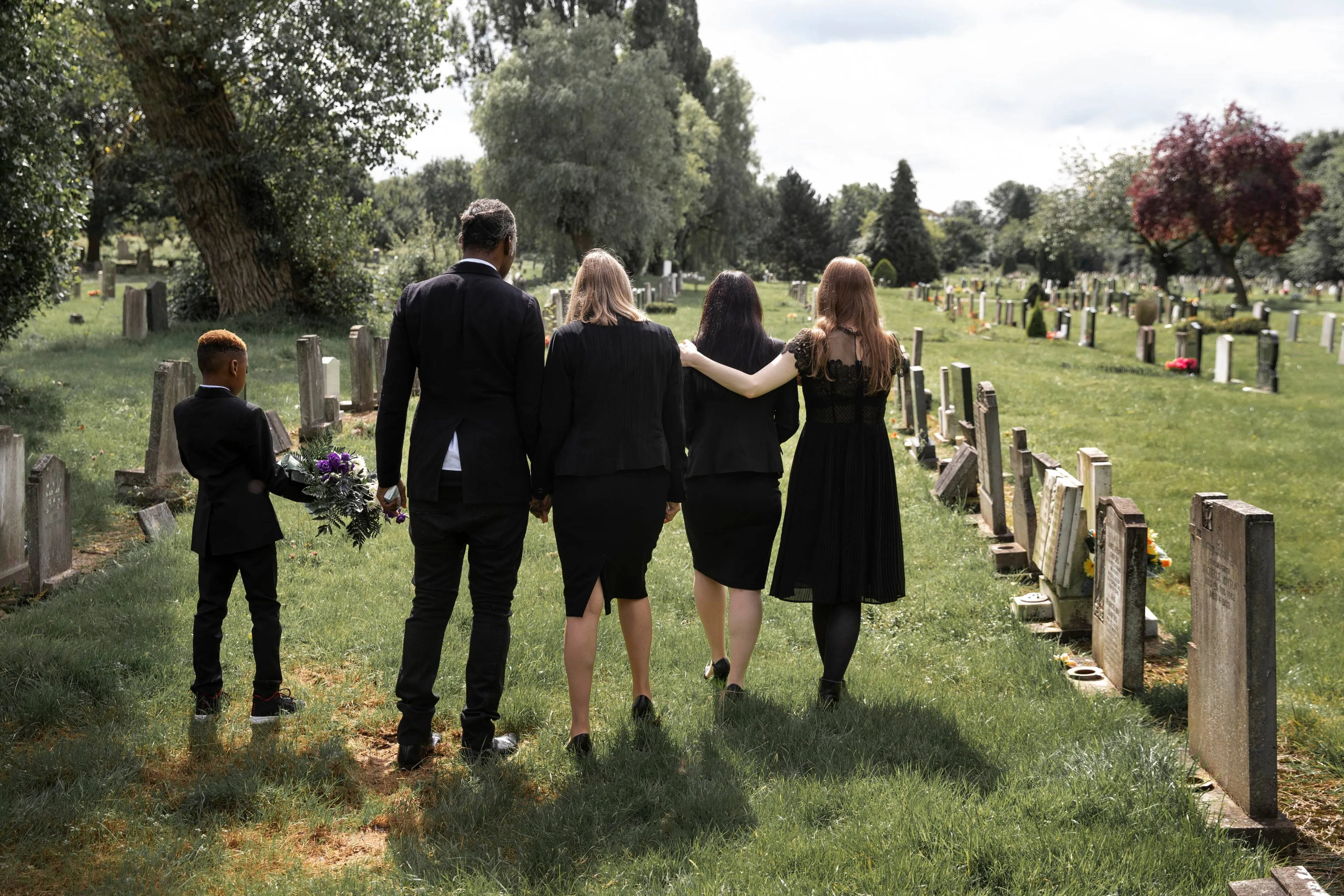 family-visiting-grave-loved-one