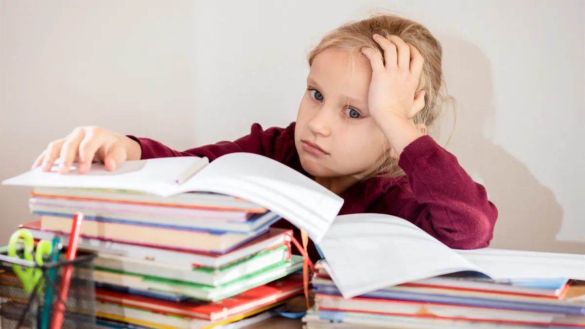 vermoeid kind gespannen leerling kind doet huiswerk basisschool leermoeilijkheden handicap