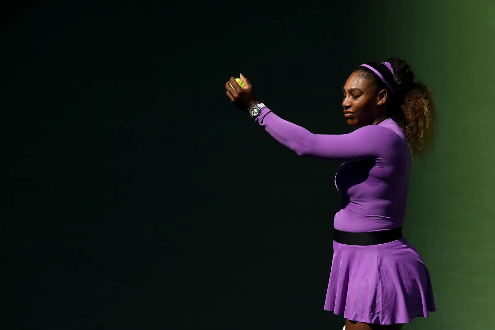 Why is Serena Williams playing with black plasters on her face?