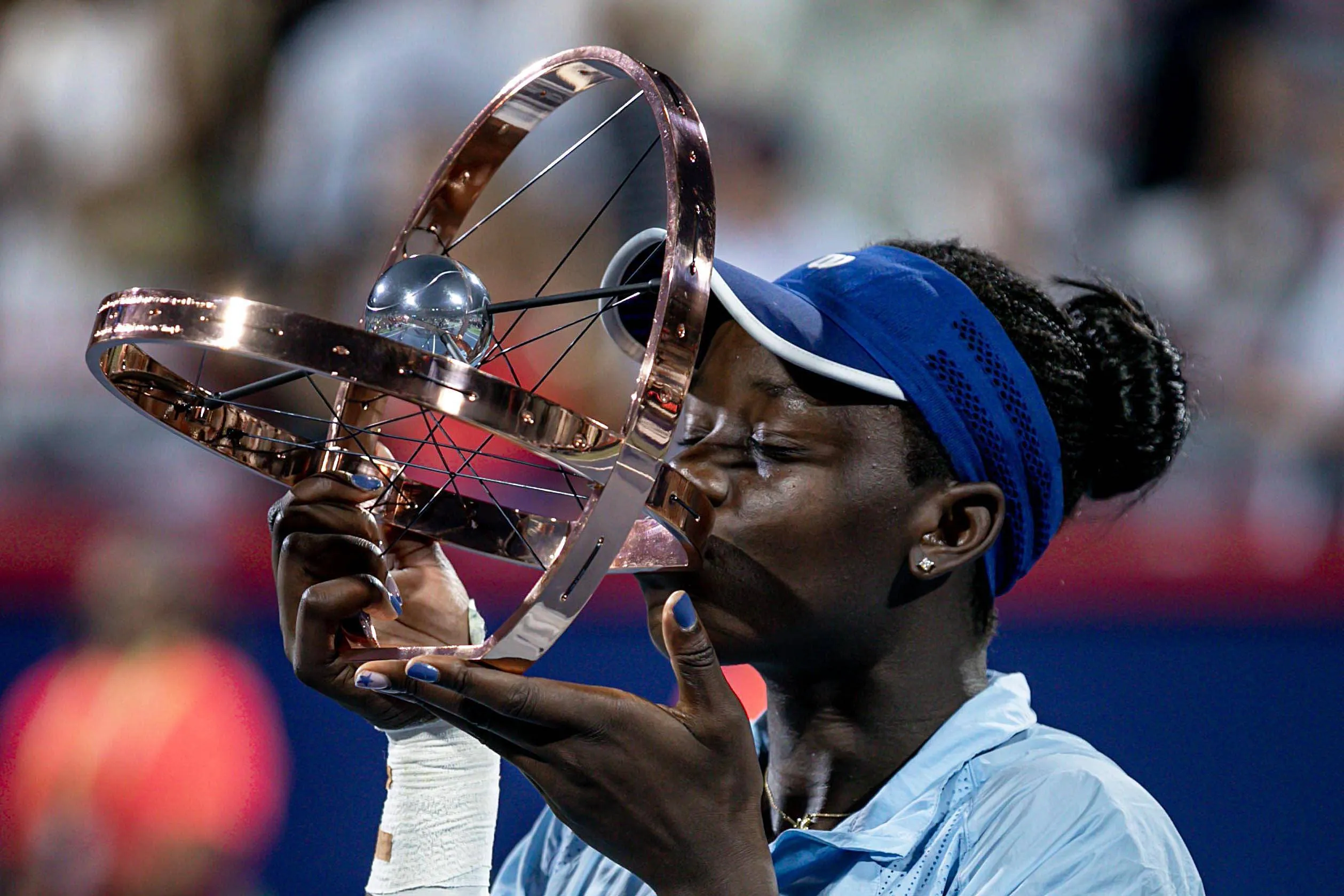 Victoria Mboko kisses the Canadian Open trophy in 2025 after her triumphant run