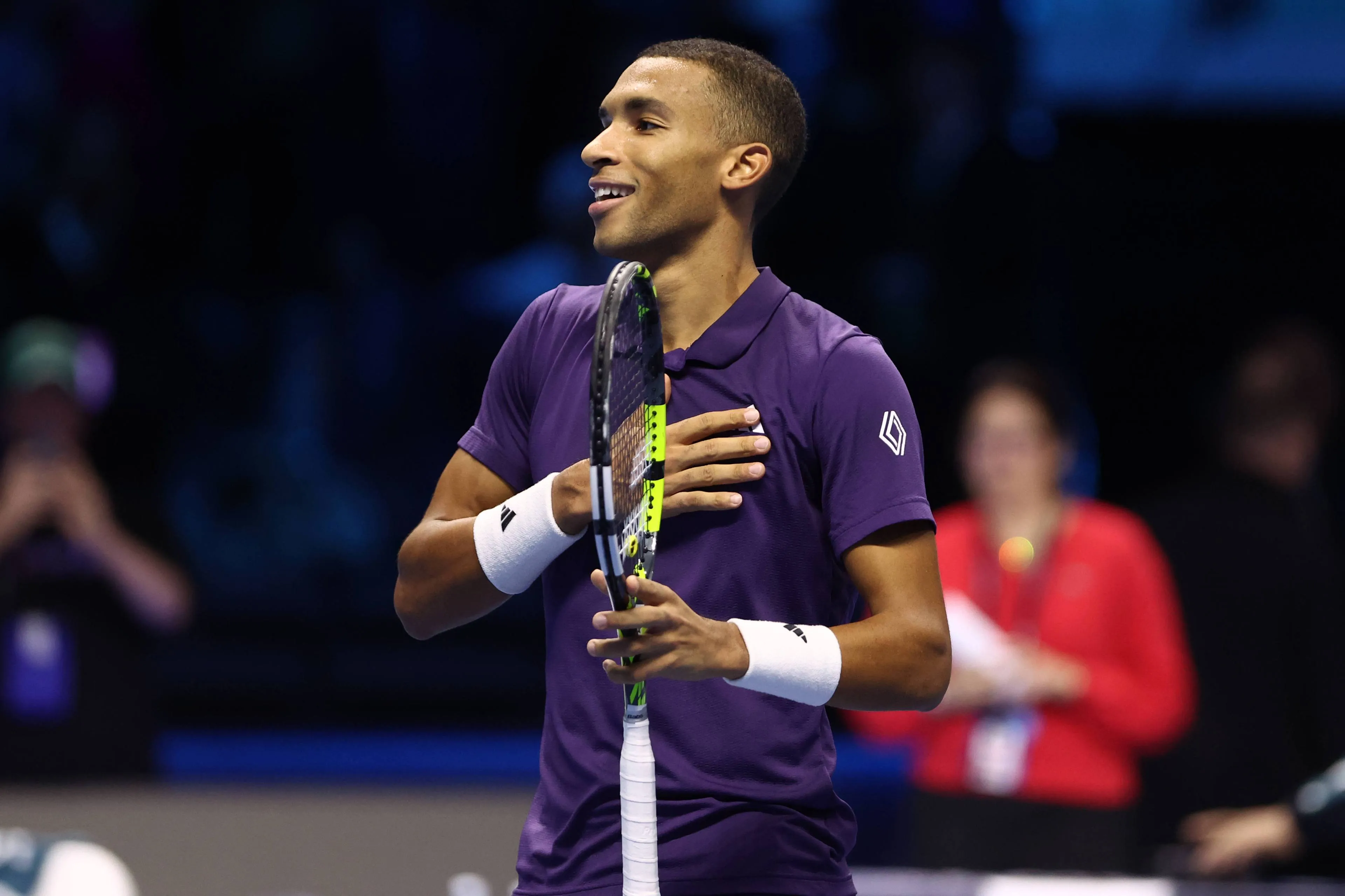 Felix Auger-Aliassime touches his chest after advancing to the semifinals of the 2025 ATP Finals