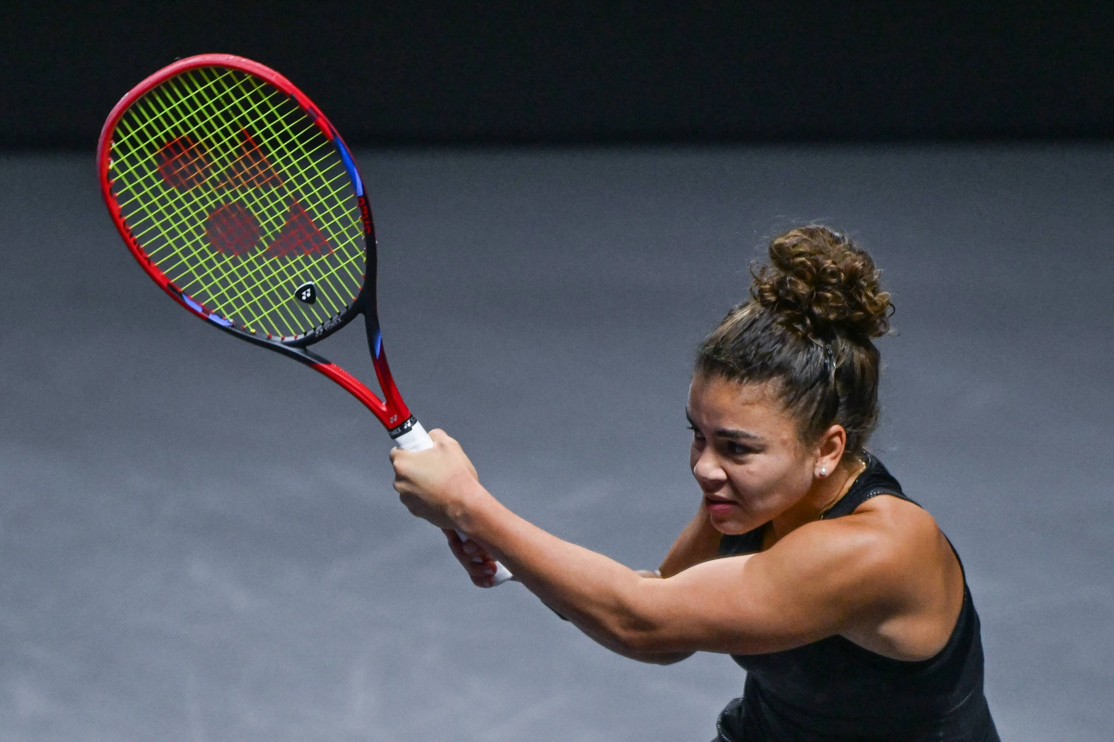 Jasmine Paolini swinging her racket after a backhand