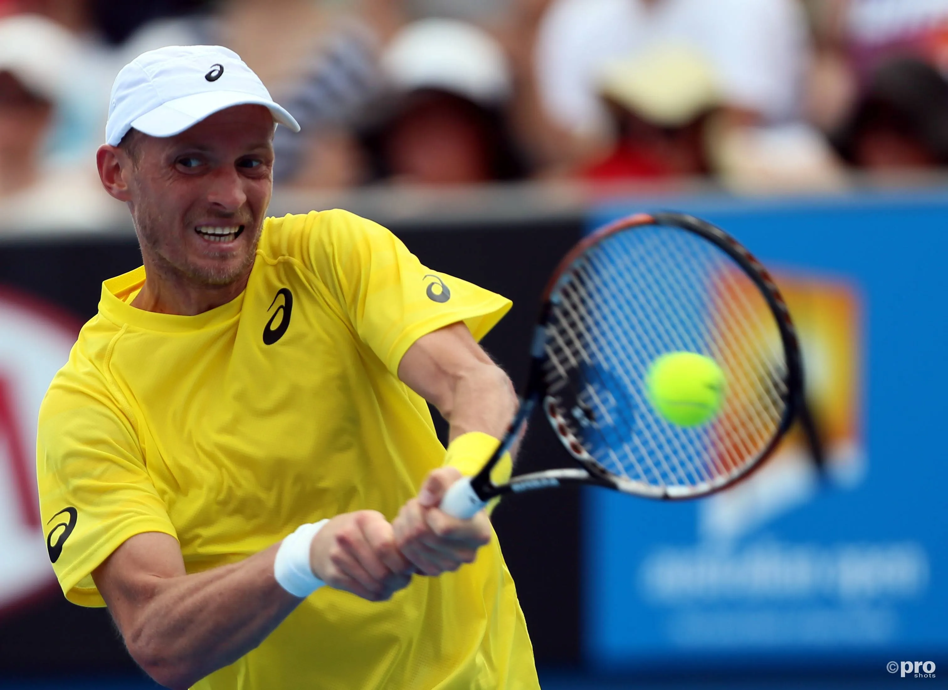 Nikolay Davydenko of Russia returns a shot in the men's singles first round match against Richard Gasquet of France at 2014 Australian Open