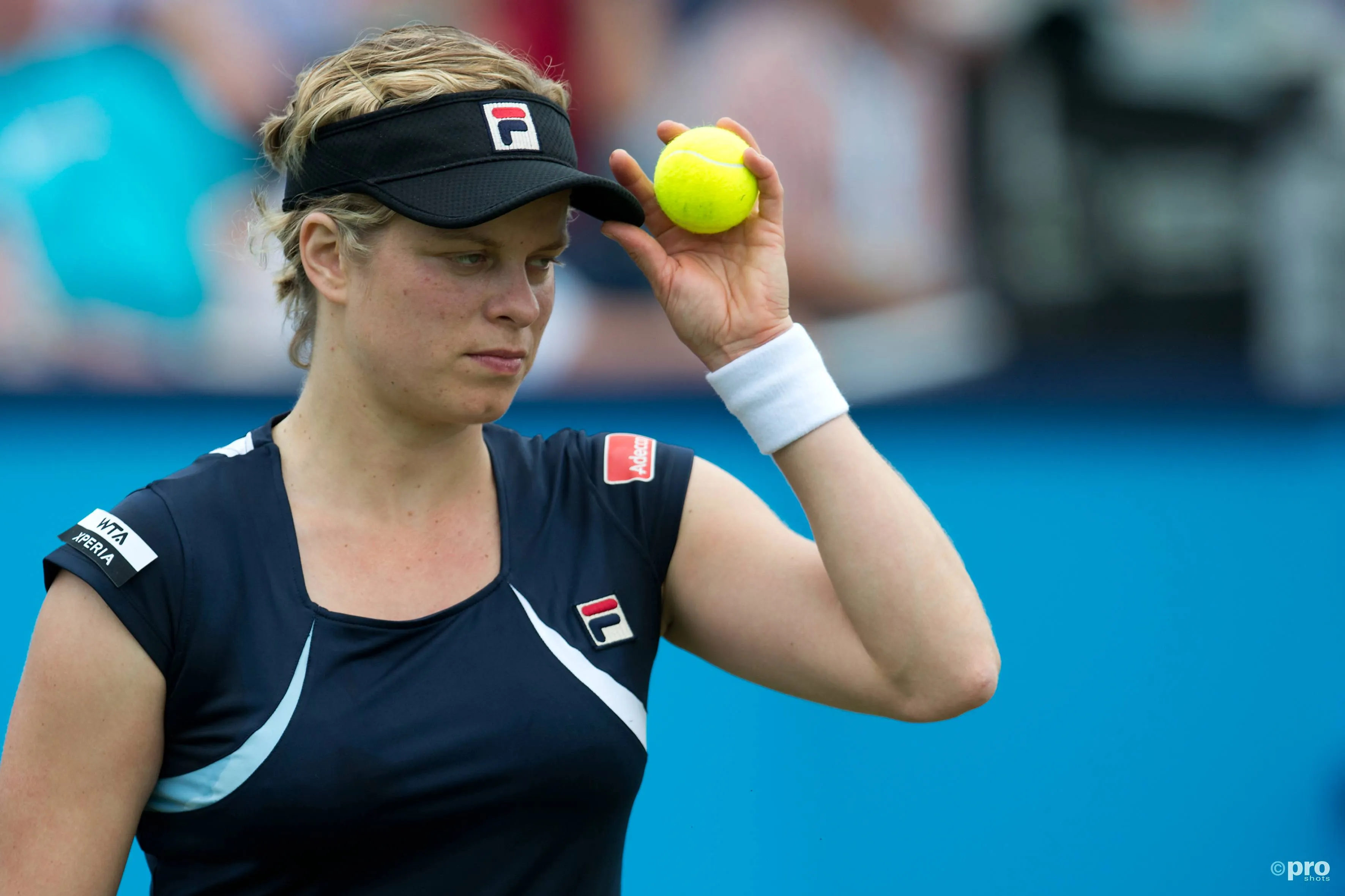 Kim Clijsters holds visor