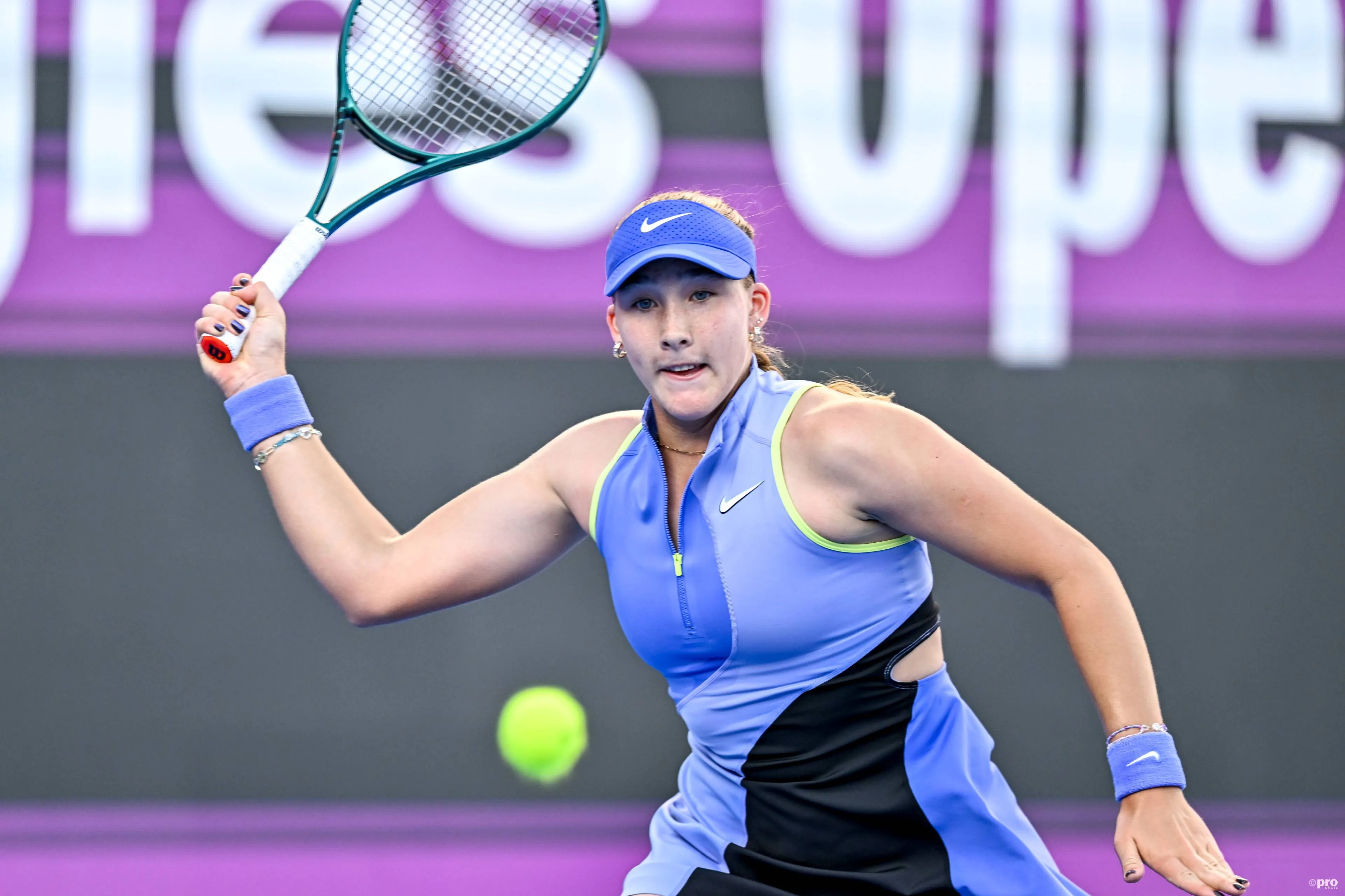 Mirra Andreeva swats return.