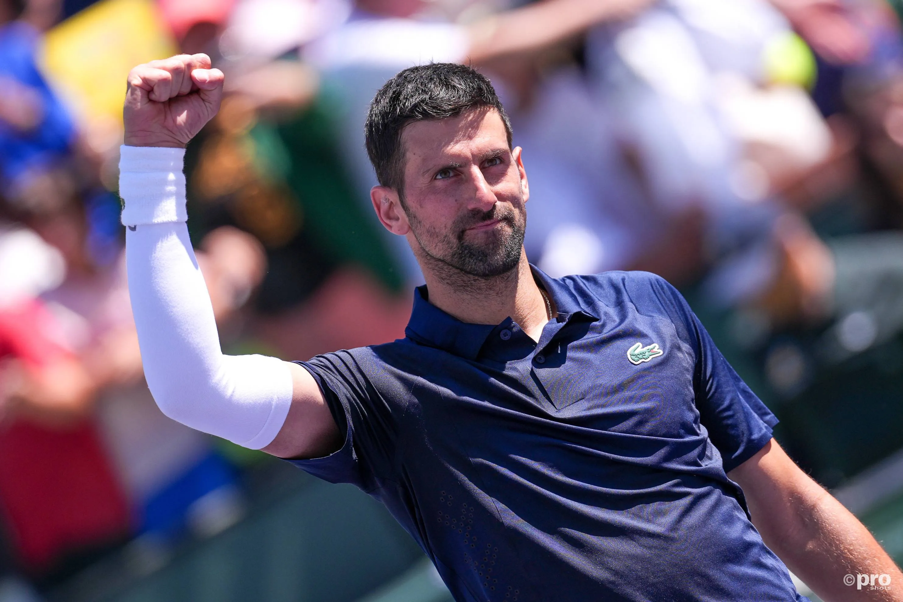Novak Djokovic raises fist to crowd.
