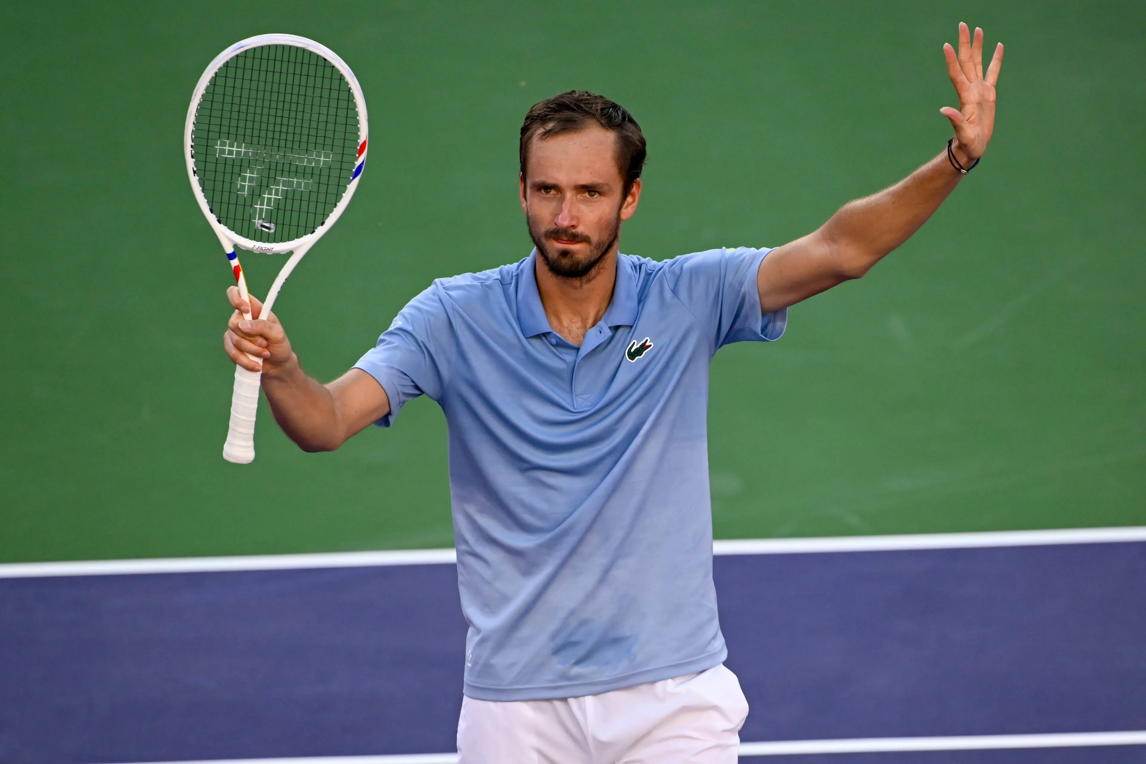 Medvedev waves racquet.