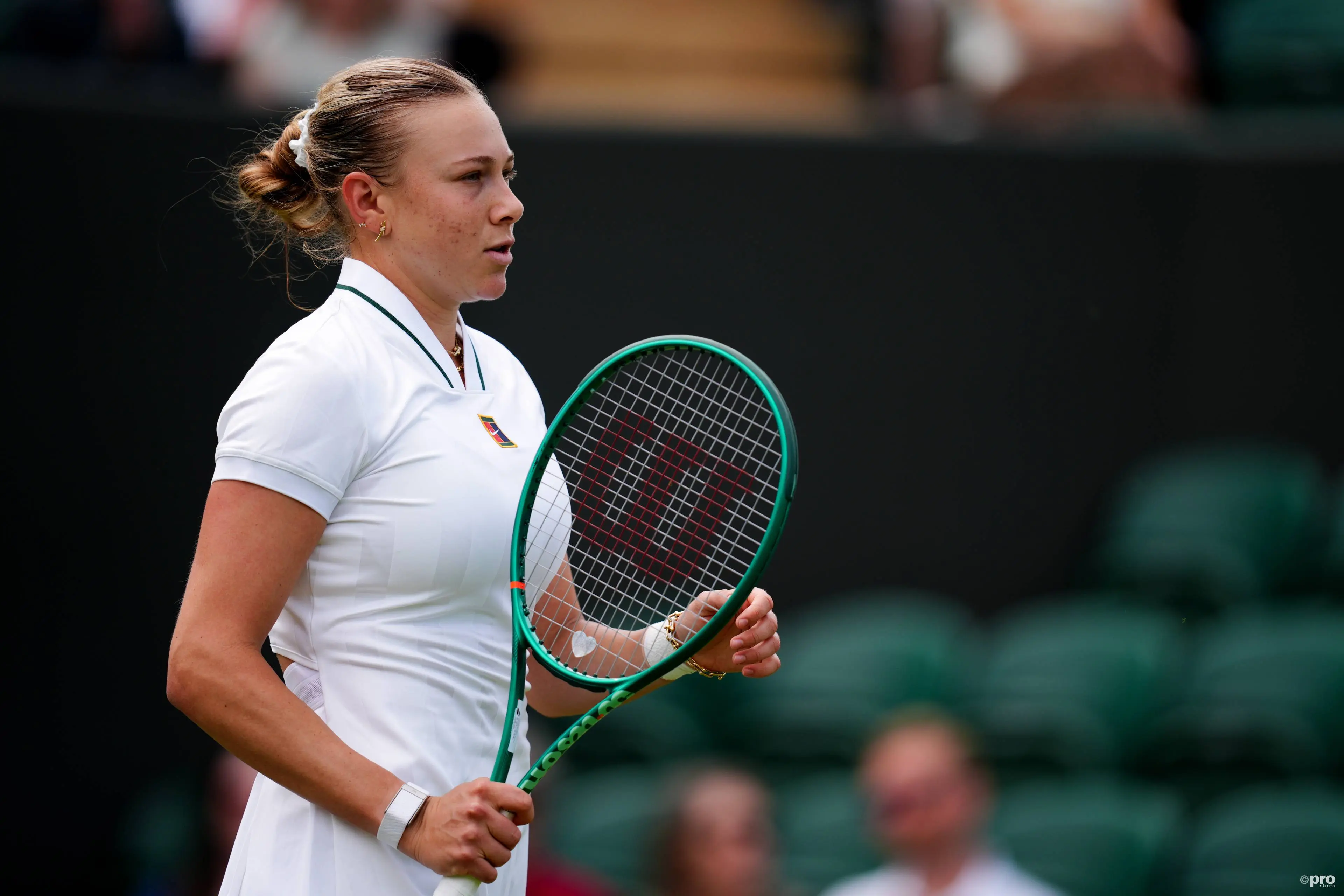 Anisimova looks on.