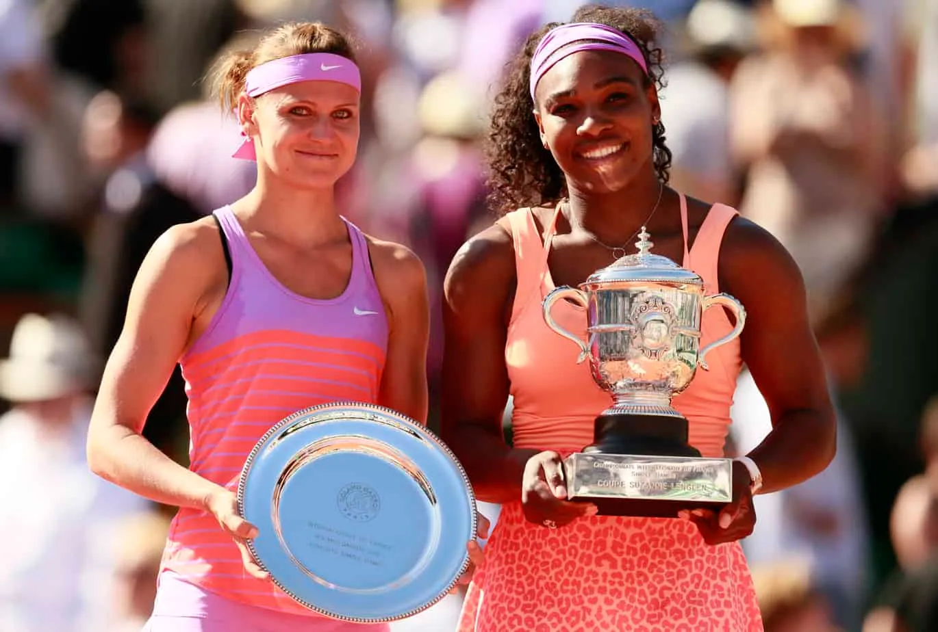 Serena Williams holding the champion's trophy at the 2015 French Open alongside runner-up Lucie Safarova