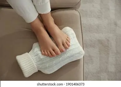 woman-warming-feet-hot-water-260nw-1901406373