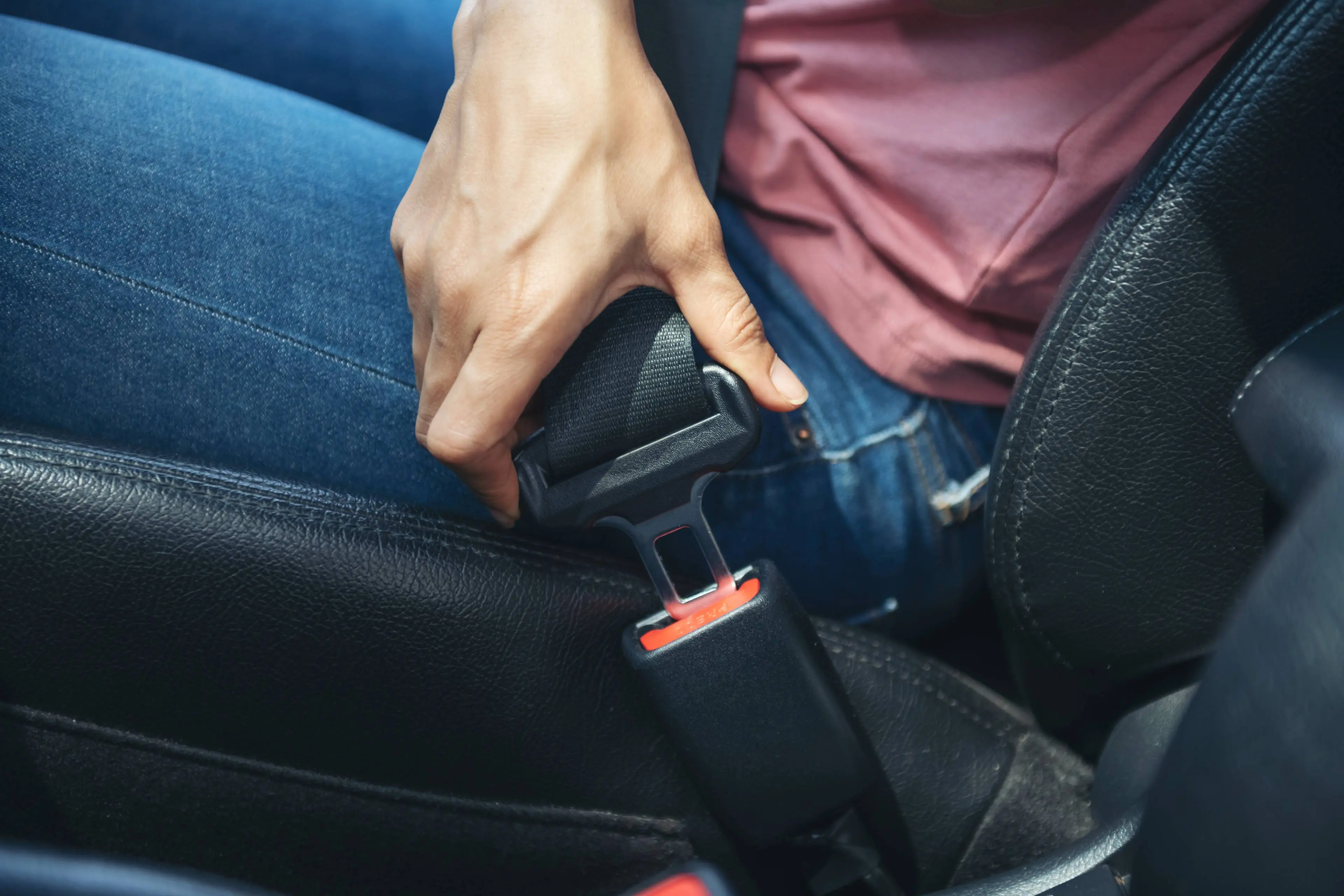 woman-hand-fastening-seatbelt-car-cropped-image-woman-sitting-car-putting-her-seat-belt-safe-driving-concept