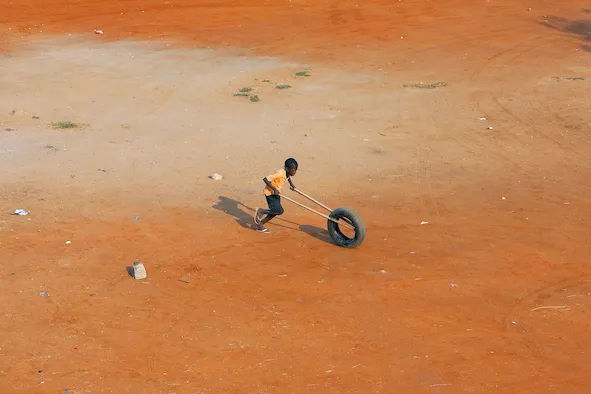 eric van den brulle angolan boy with tire