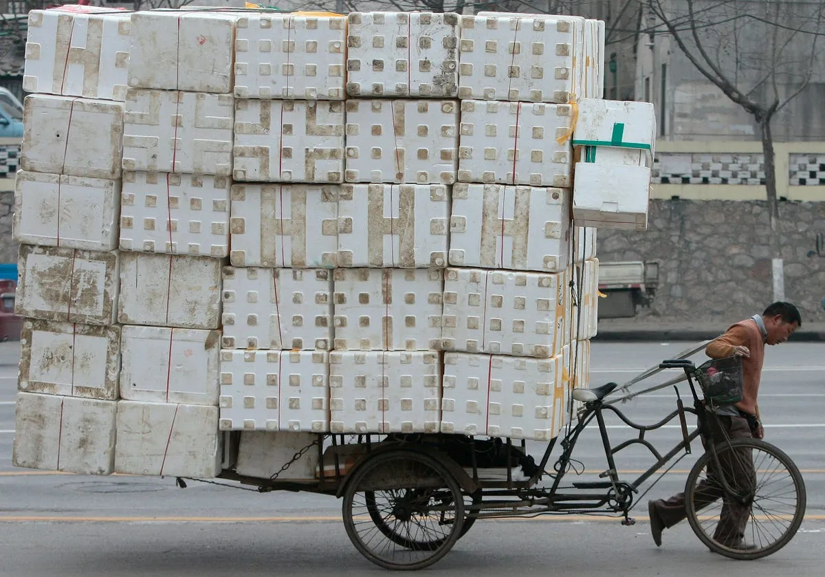 a migrant worker pulls a cart loaded with discarded plastic foam for recycling in nanjing china