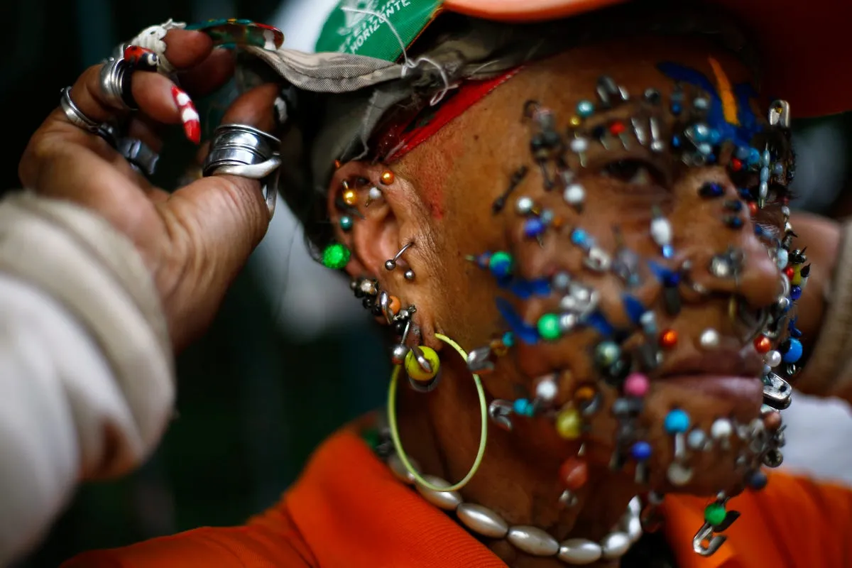 a street cleaner and fan of the brazilian national world cup soccer team shows the myriad of piercings on her face on a street in belo horizonte july 3 2014