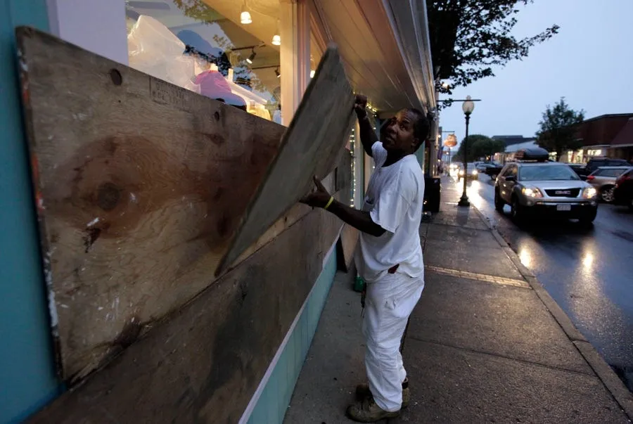 carpenter archie robertson of vineyard haven mass covers plate glass windows on a store front
