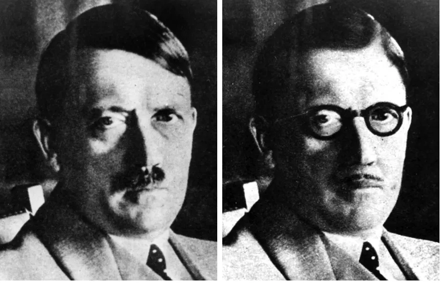 hitler with a thinner mustache thick rimmed glasses and a slightly new hairstyle