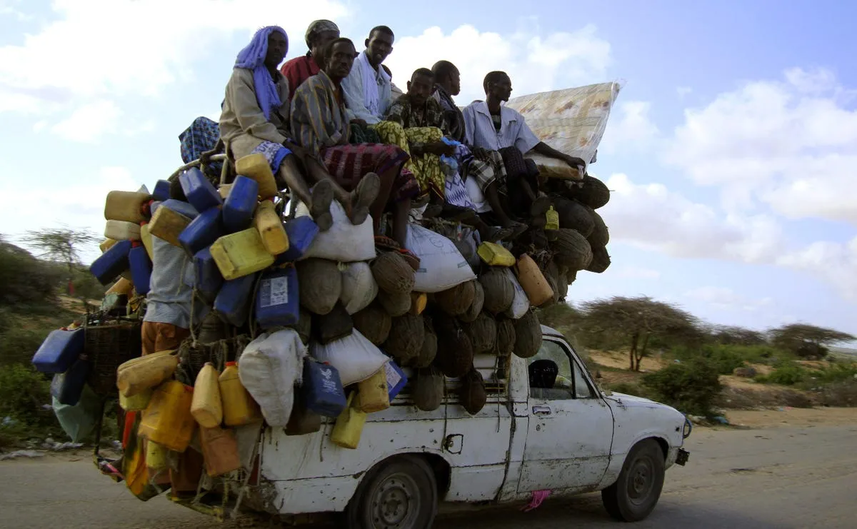 this truck in mogadishu somalia is overloaded with people and supplies including milk